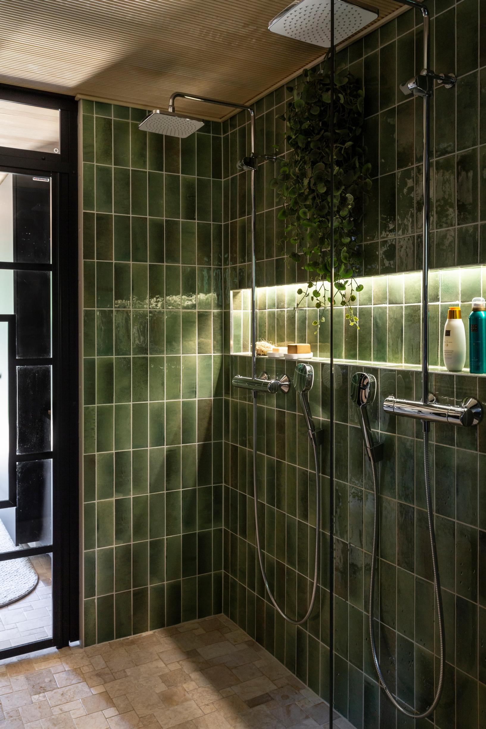 A bathroom tiled in green.