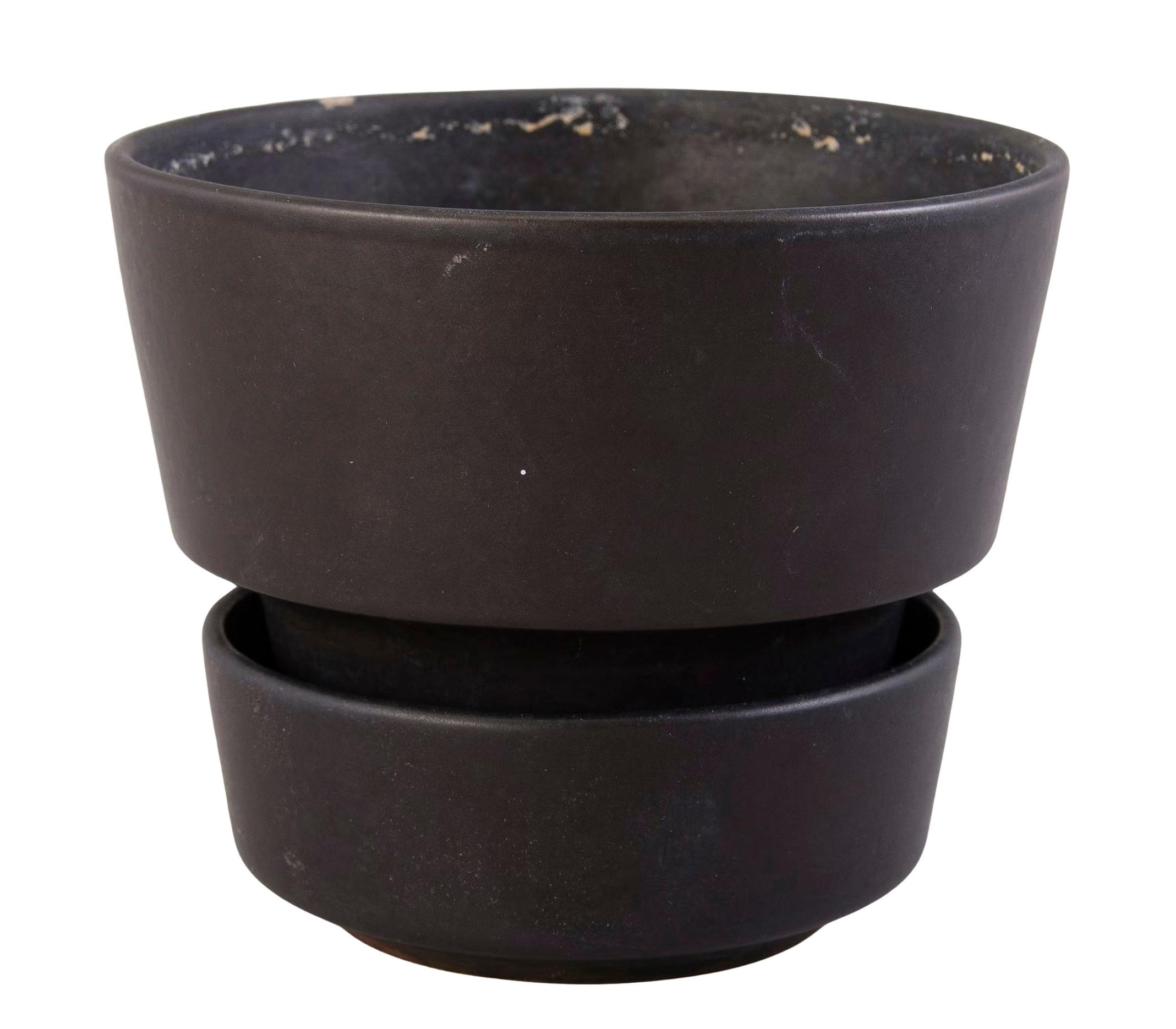 This Richard Lindh flowerpot widens toward the top.