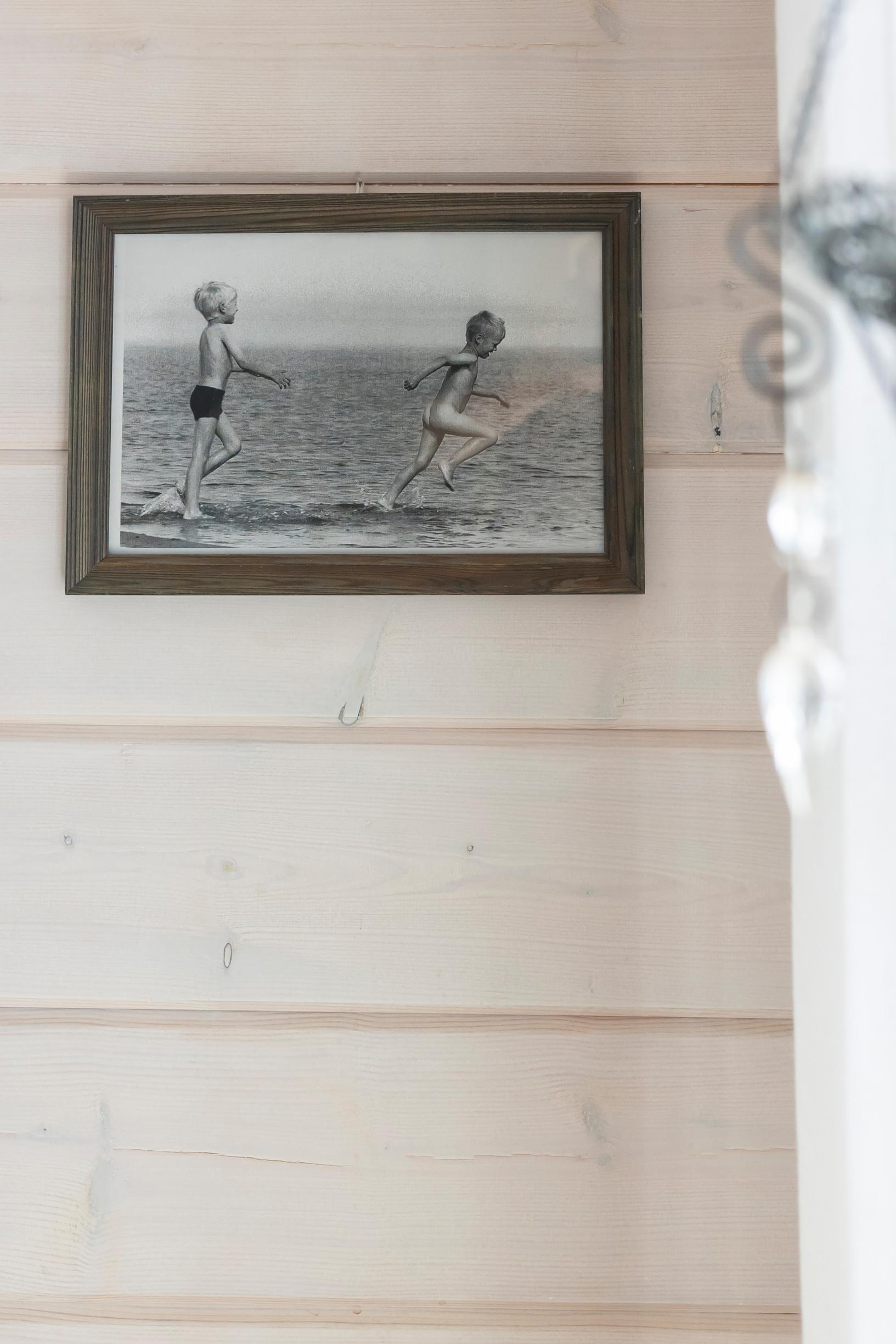 a black-and-white photograph on a light-colored log wall