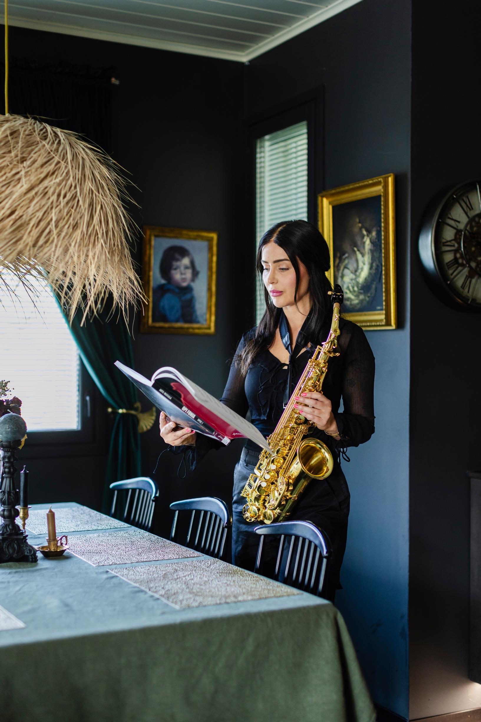 Asta Vehviläinen with a saxophone