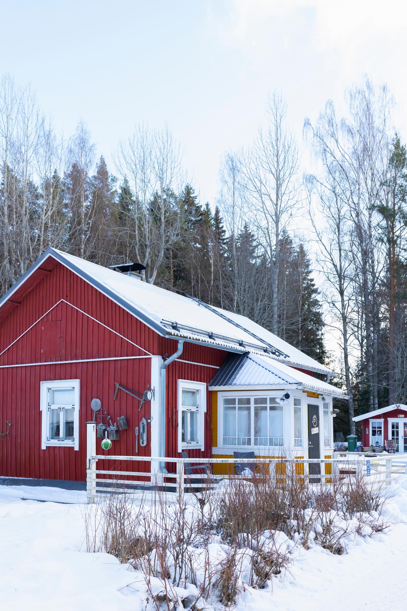 a red cottage surrounded by snow