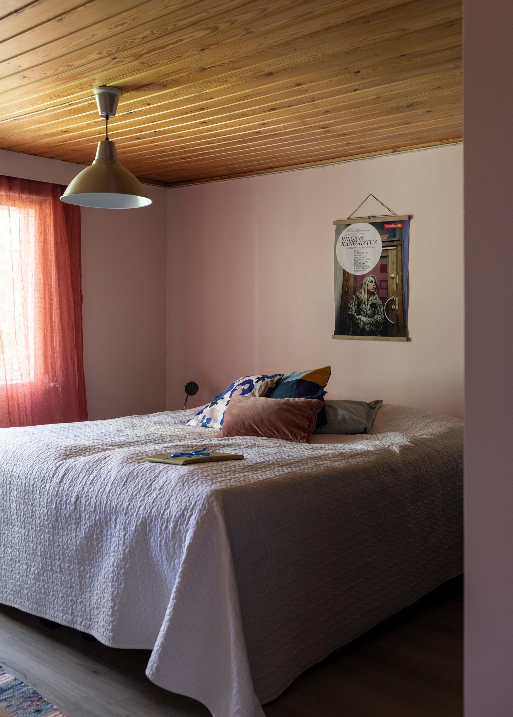 A bedroom with a poster on the wall