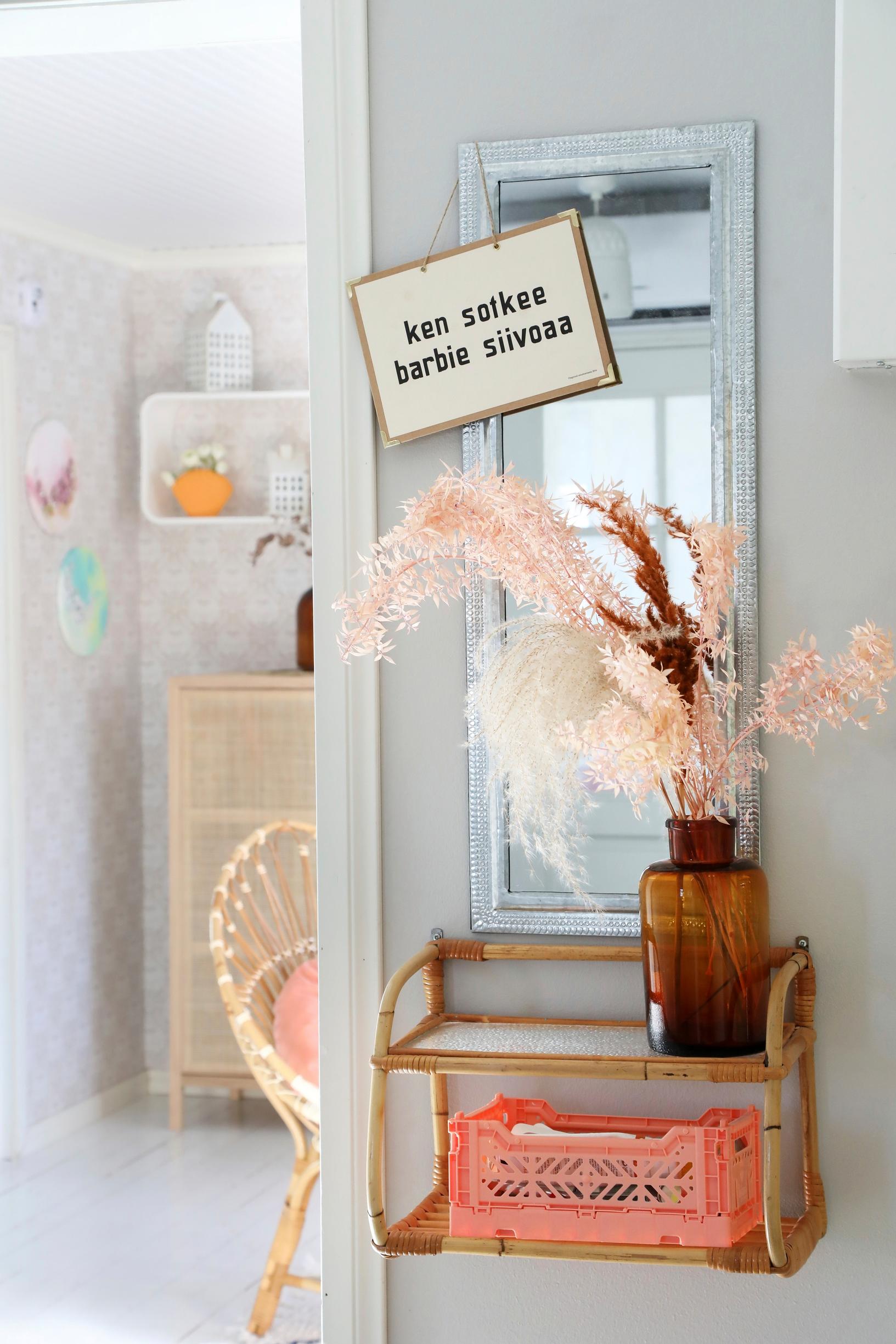 A rattan shelf and an apothecary bottle in the entryway.