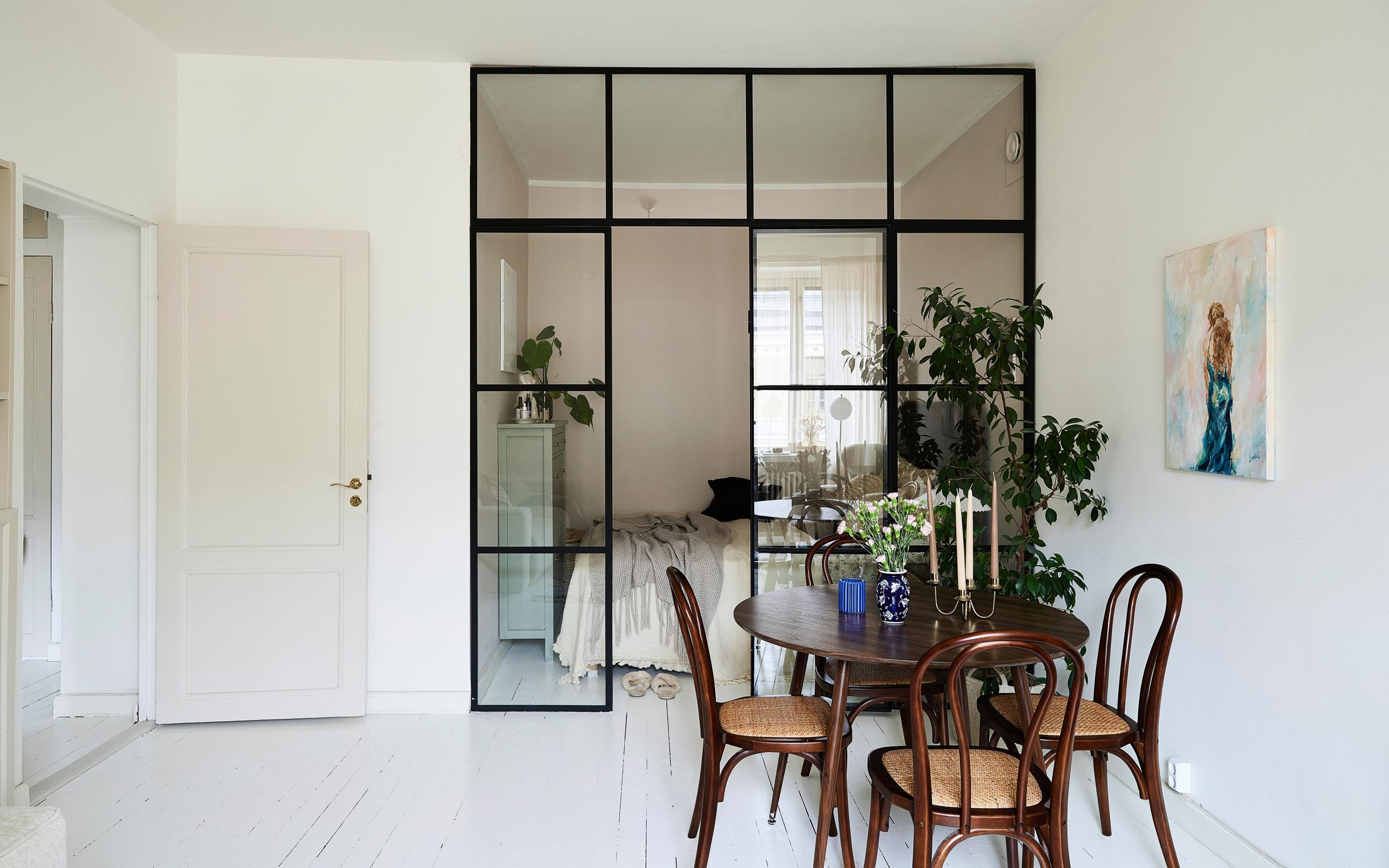 Bedroom alcove separated by a grid glass wall