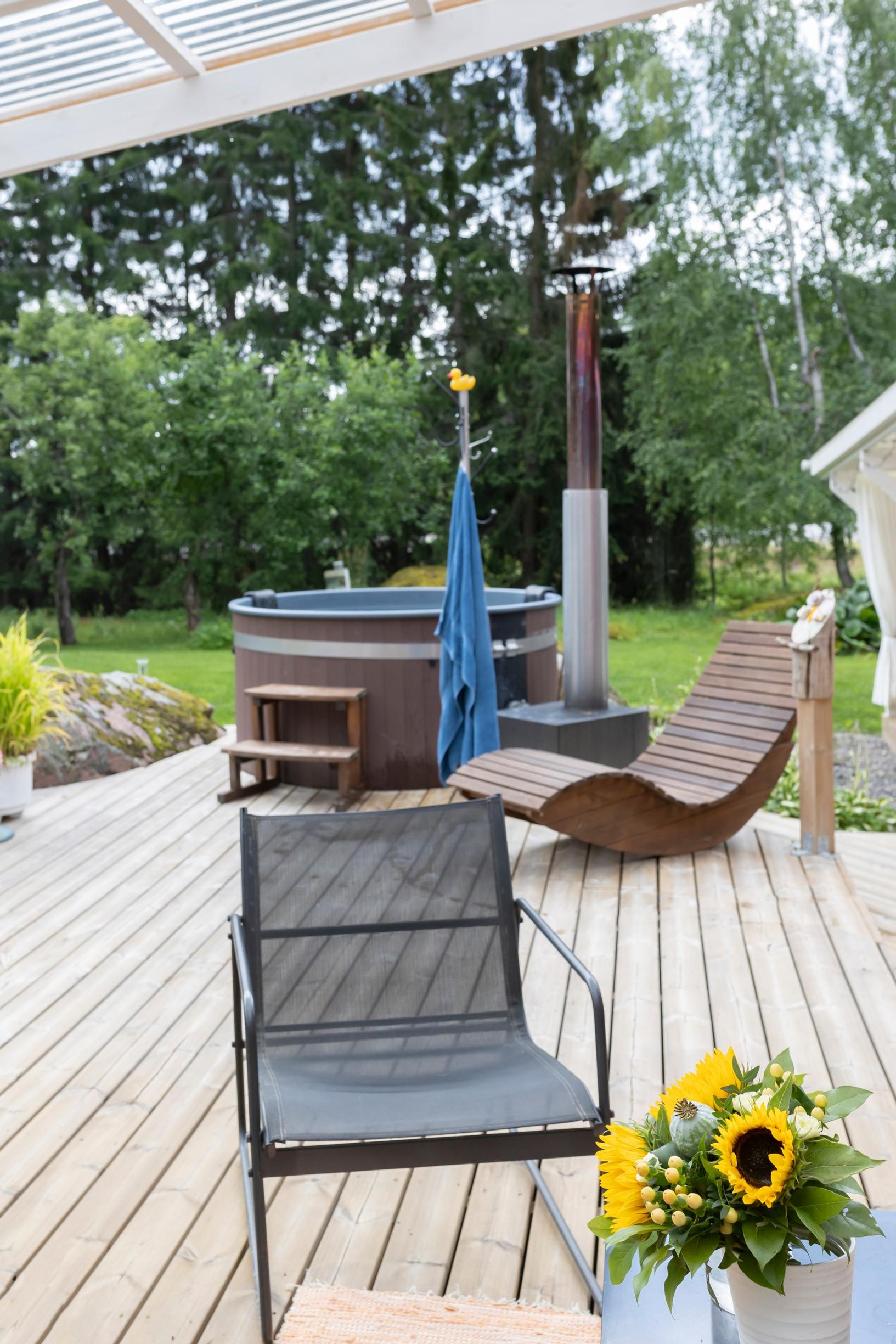 A garden chair, a lounge chair, and a hot tub on the terrace