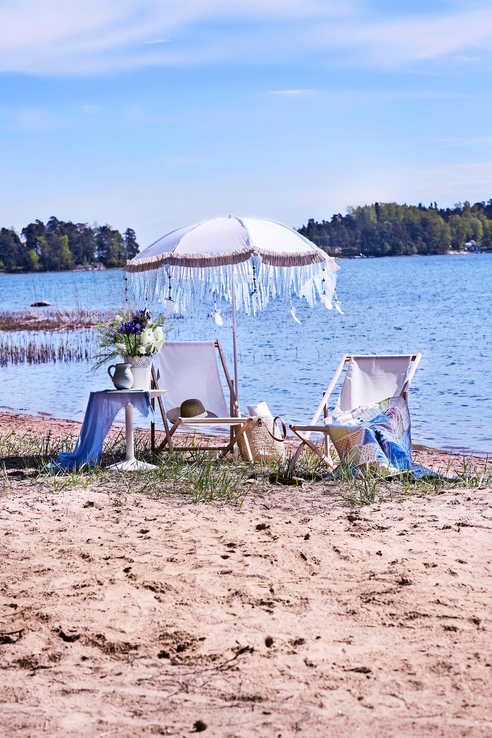 Beach umbrella and deck chairs on a sandy shore