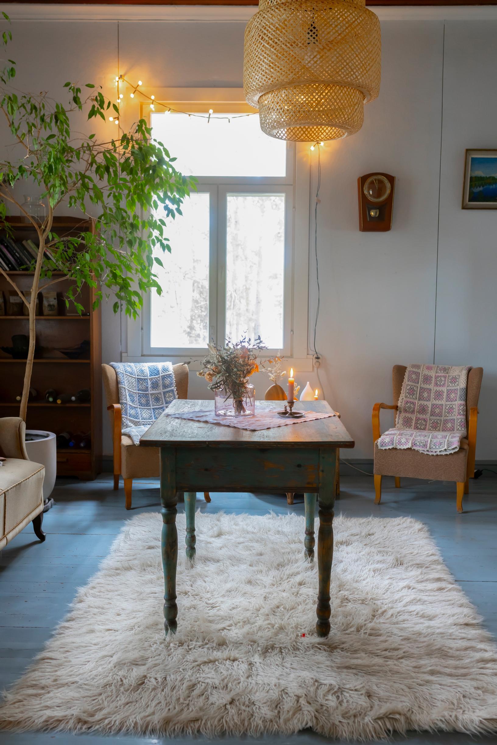 Wooden floor, old furniture, and a white fluffy rug.