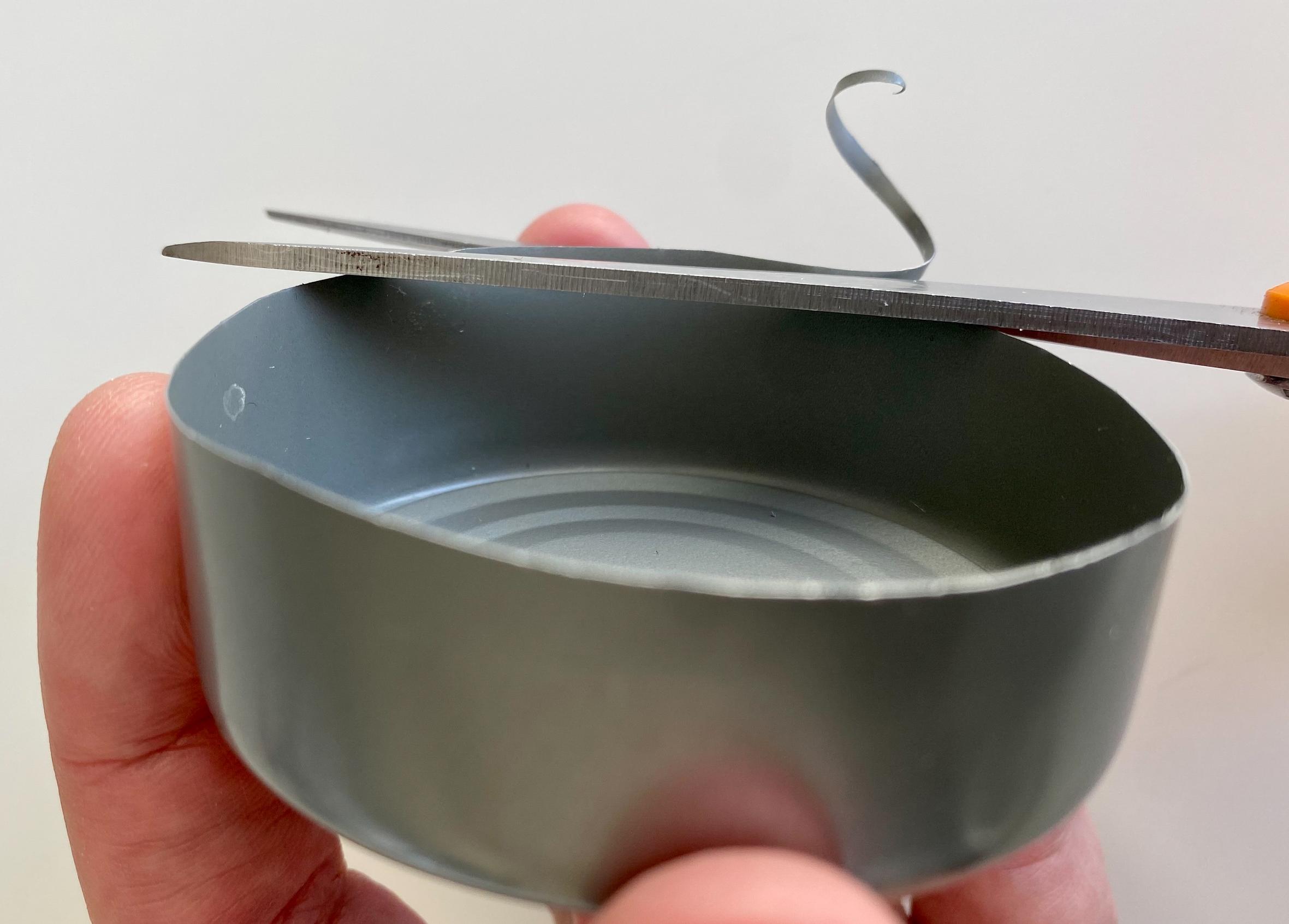 Cutting the base of the pin frog from a tin can