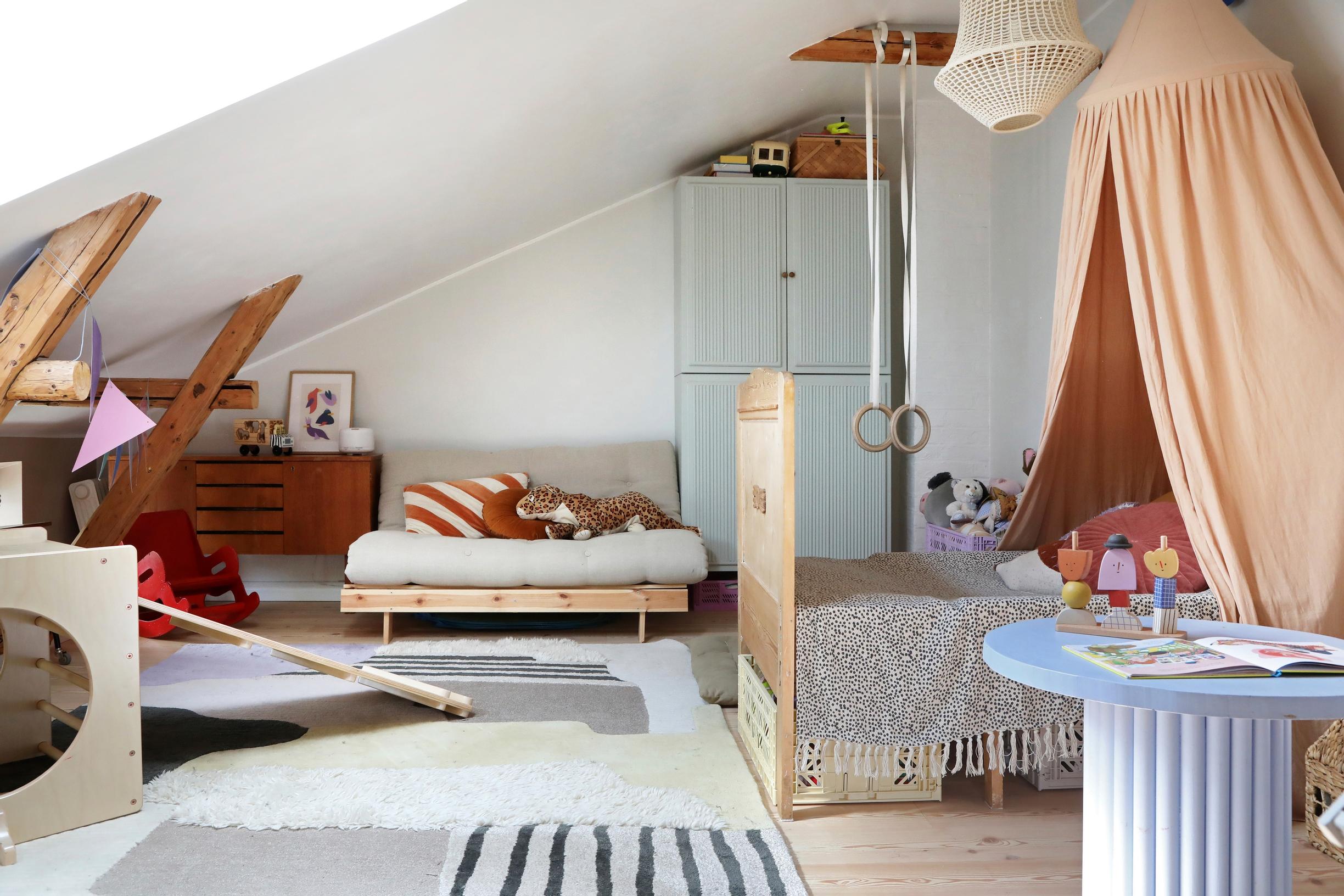 children’s room with a canopy bed and a Karup futon sofa