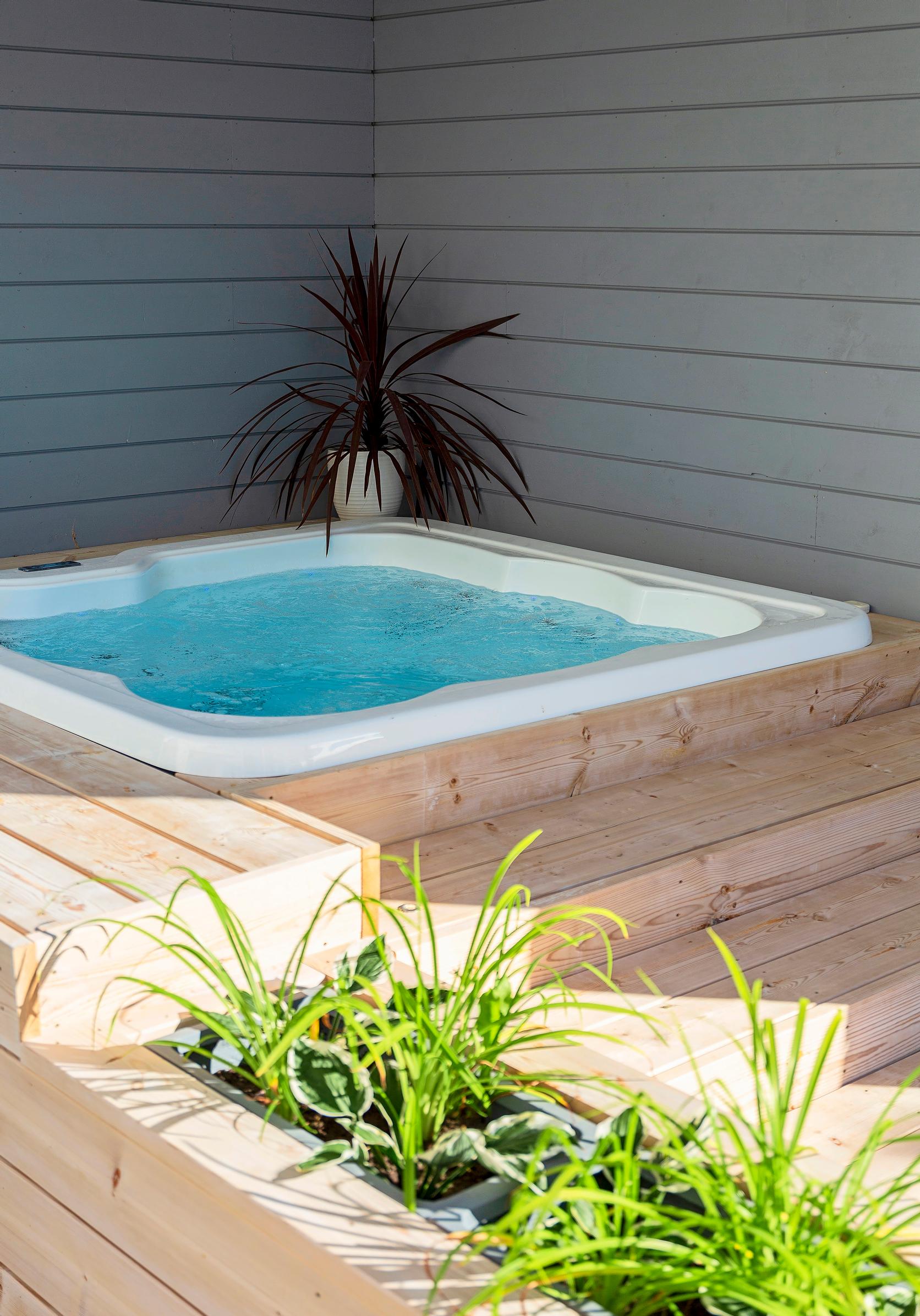 Outdoor hot tub recessed into a deck