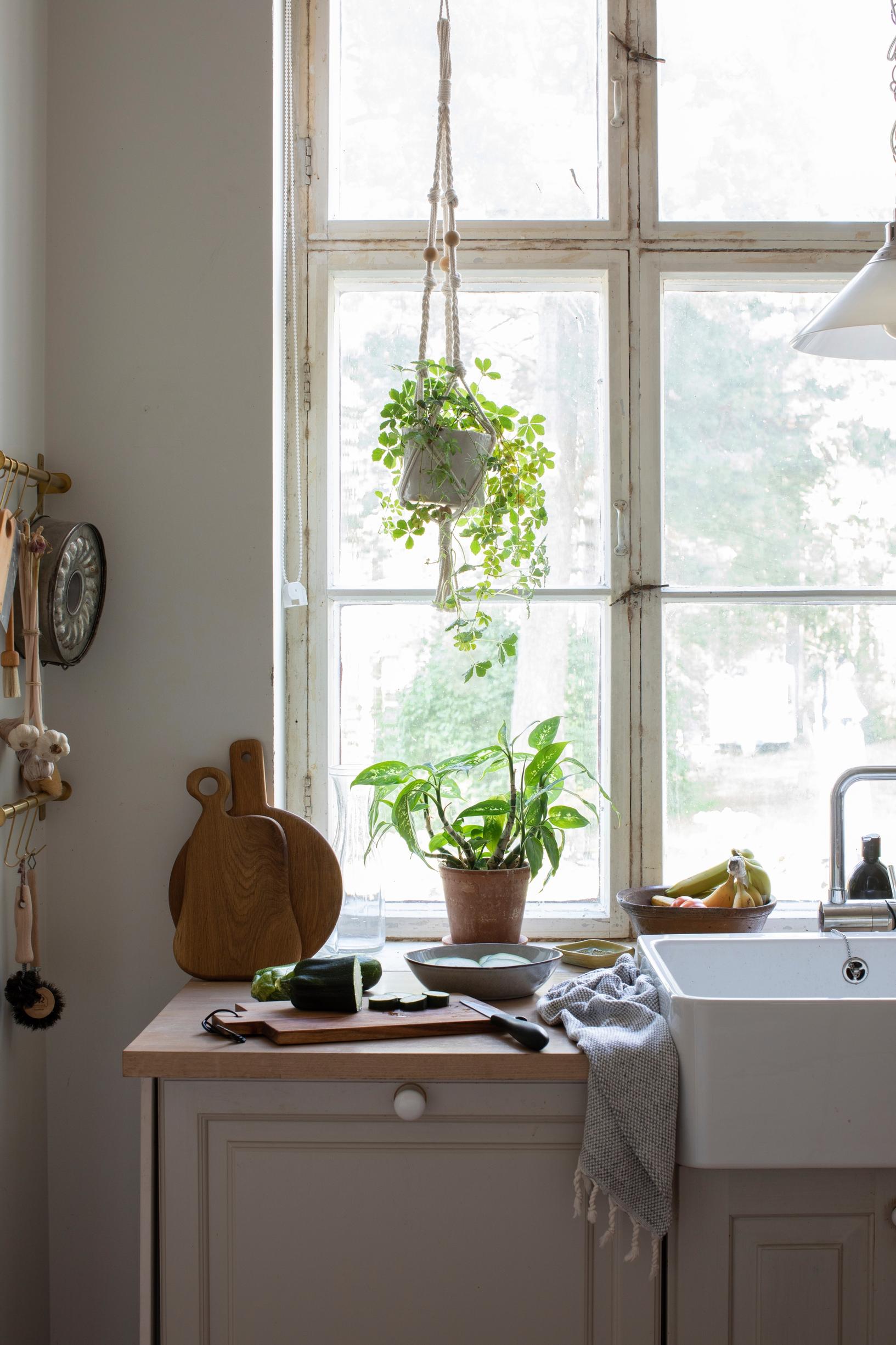 A sink and countertop placed in front of a large window
