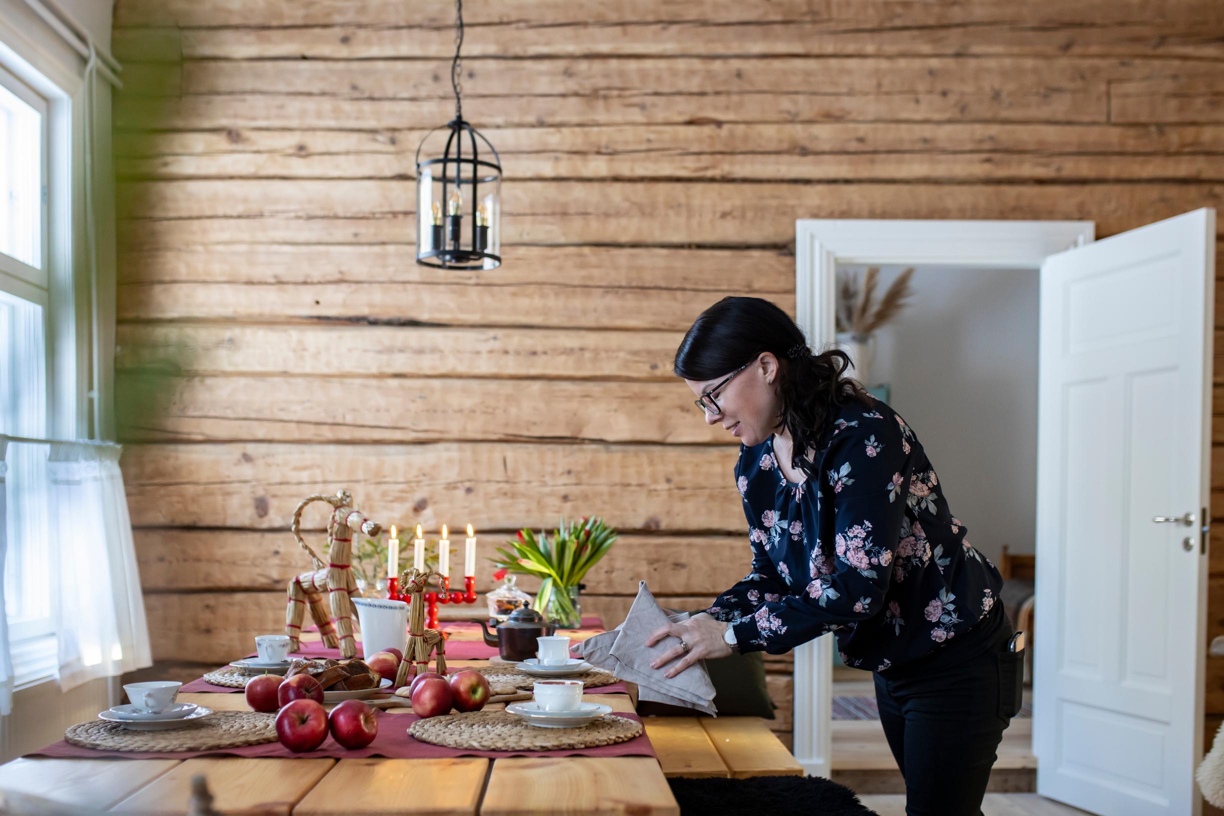 Kaisa setting the table in the vicarage’s everyday kitchen