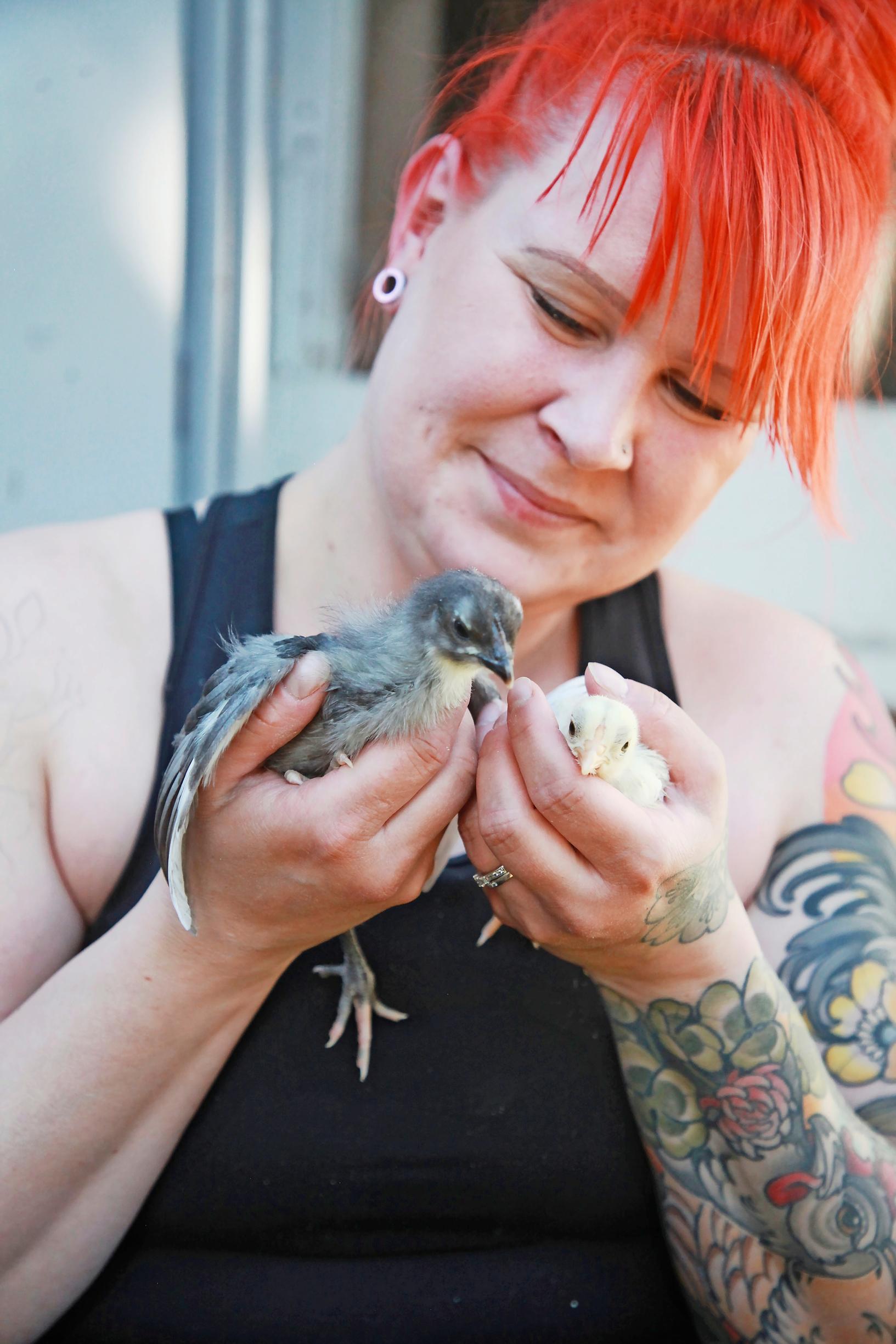 Anna-Kaisa holds chicks in her hands.