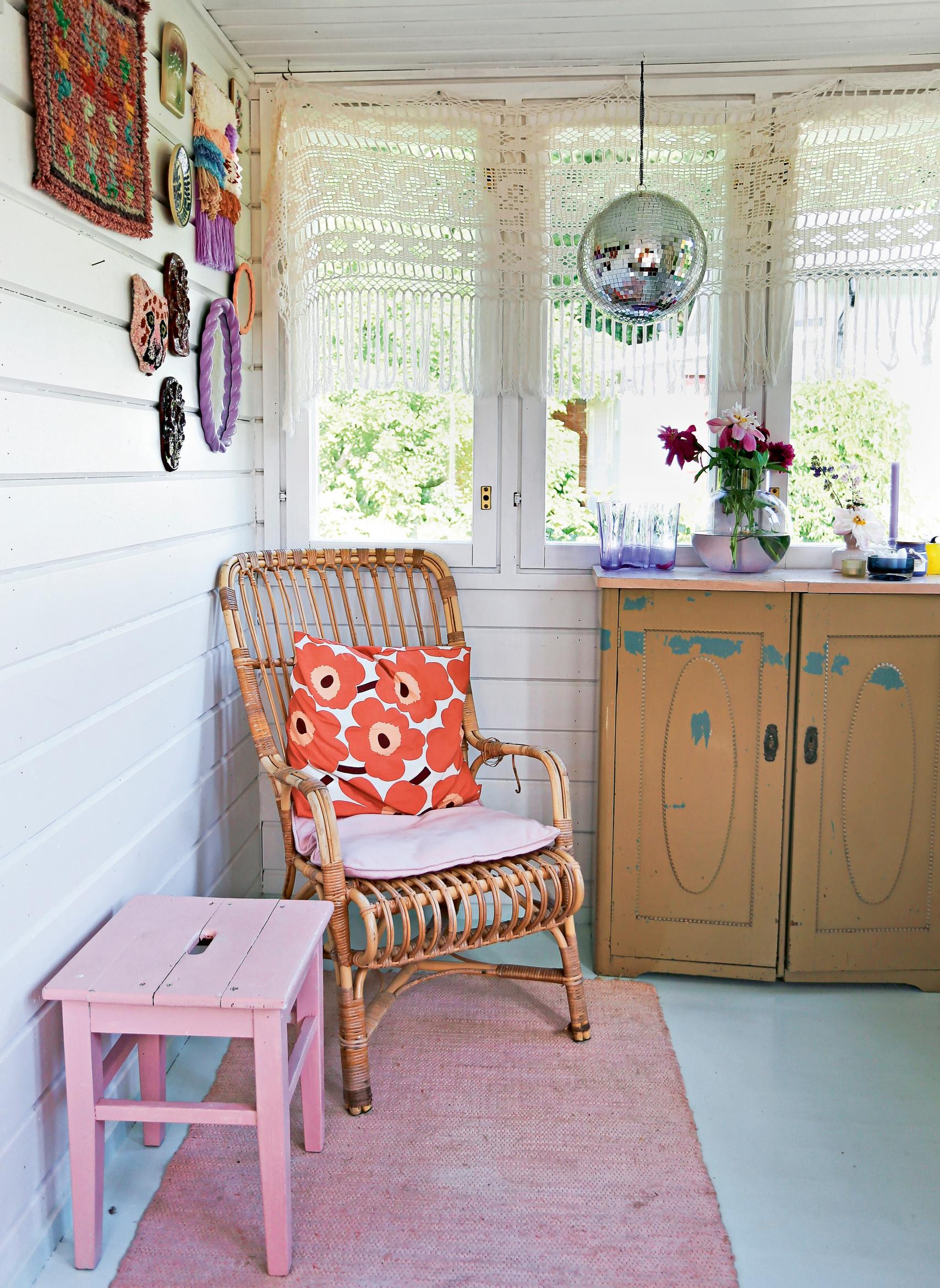 A rattan chair and old dresser in the cottage entryway