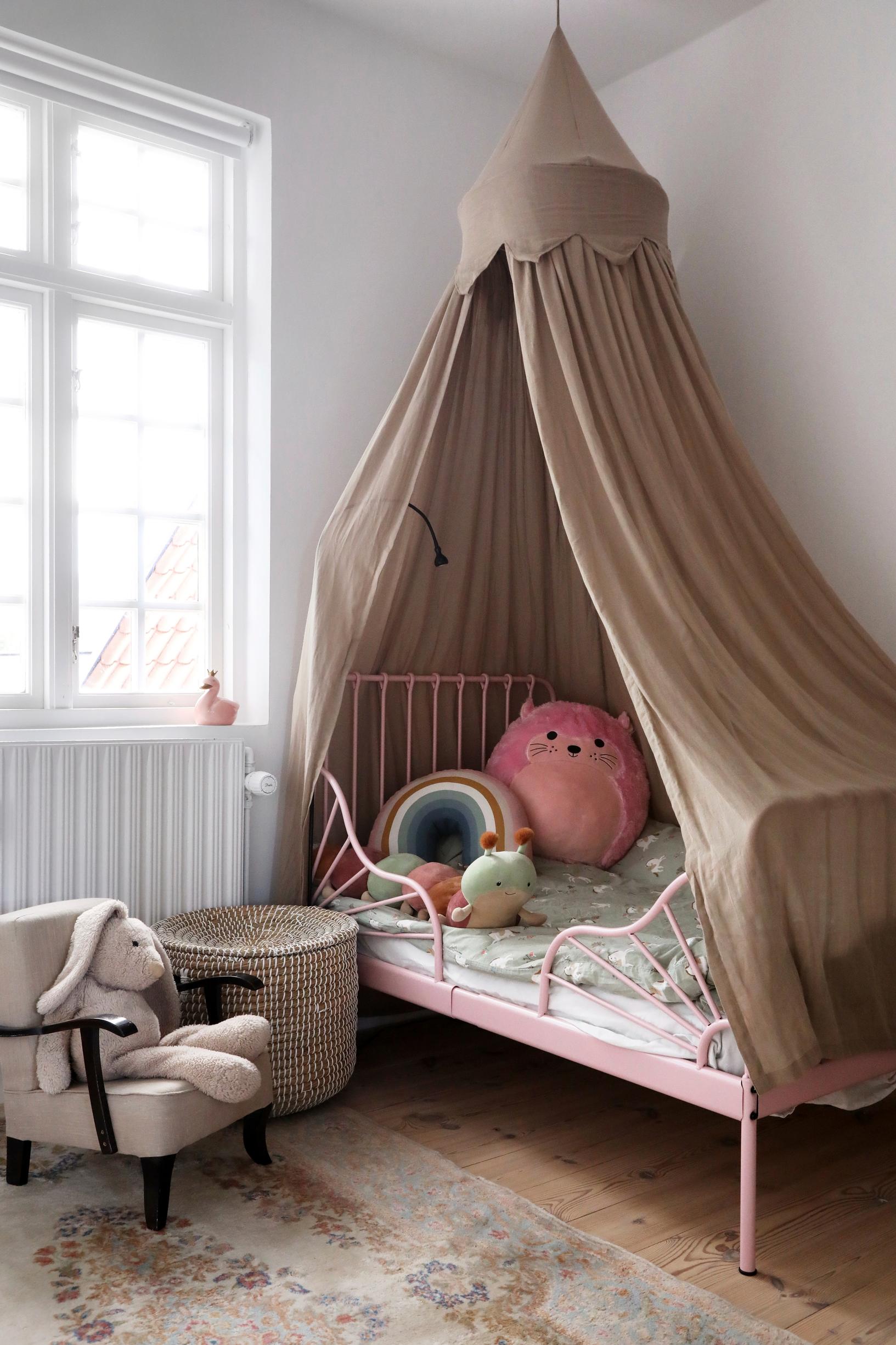 In the youngest child’s room, a canopy bed