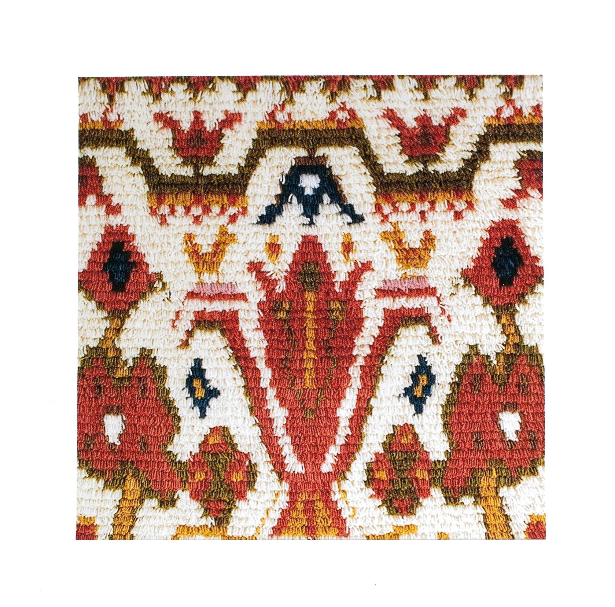 Ryijy with a white background and red-orange patterns
