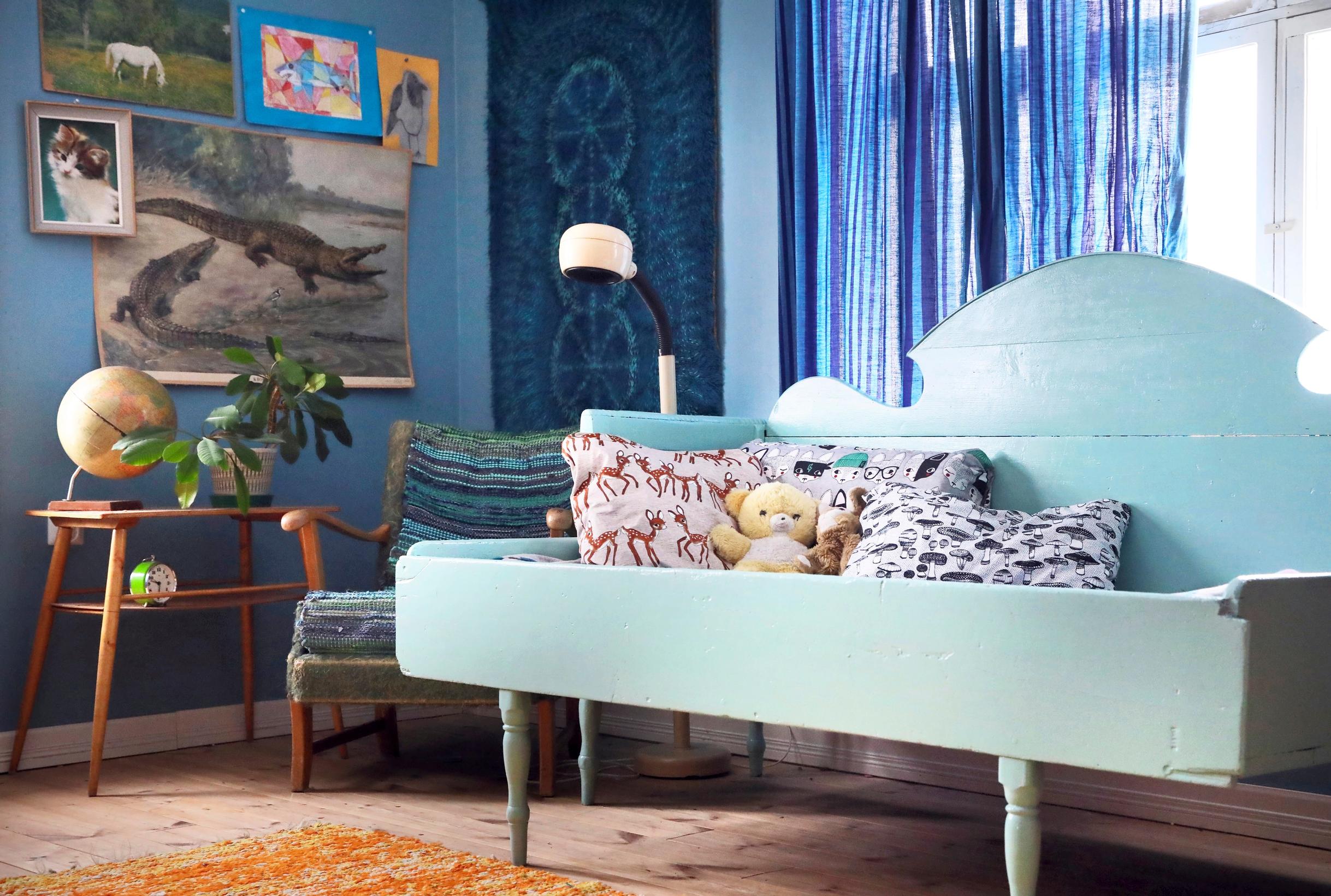A wooden sofa painted blue.