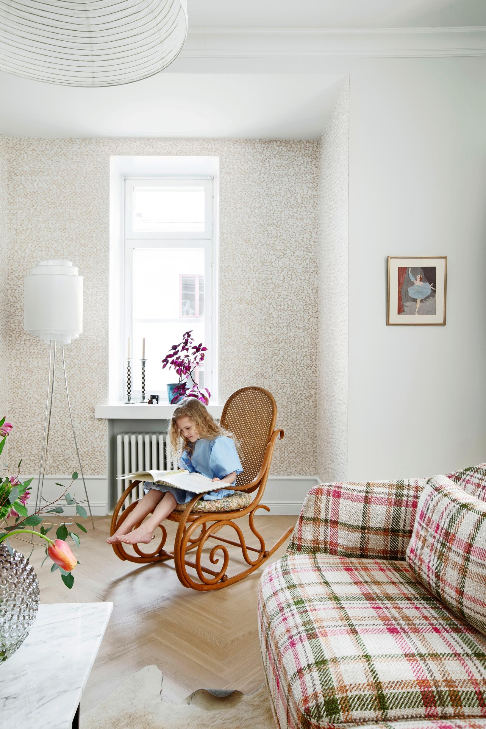 Thonet rocking chair and checkered sofa in the TV room.