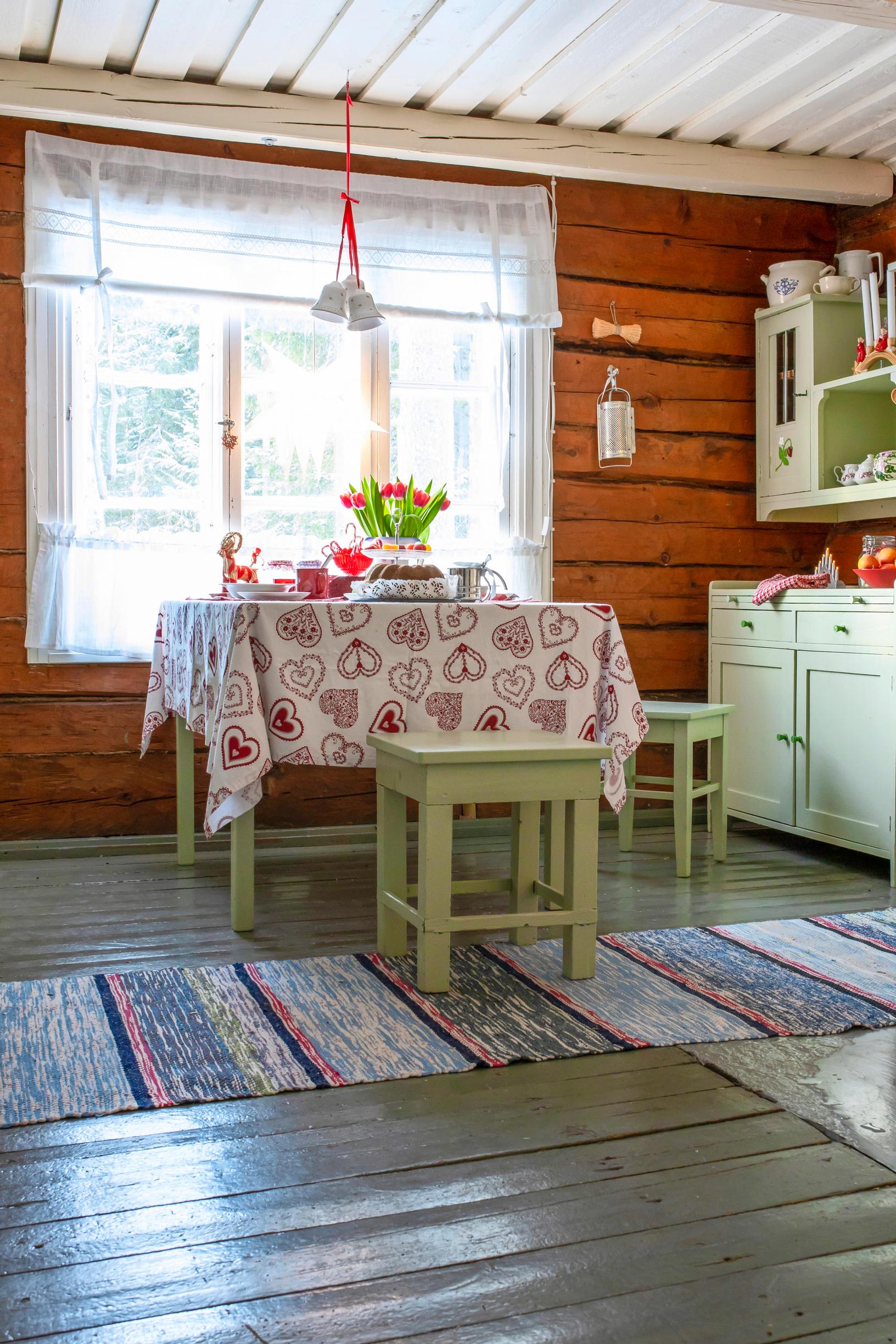 The cottage kitchen features mint-green cabinetry 