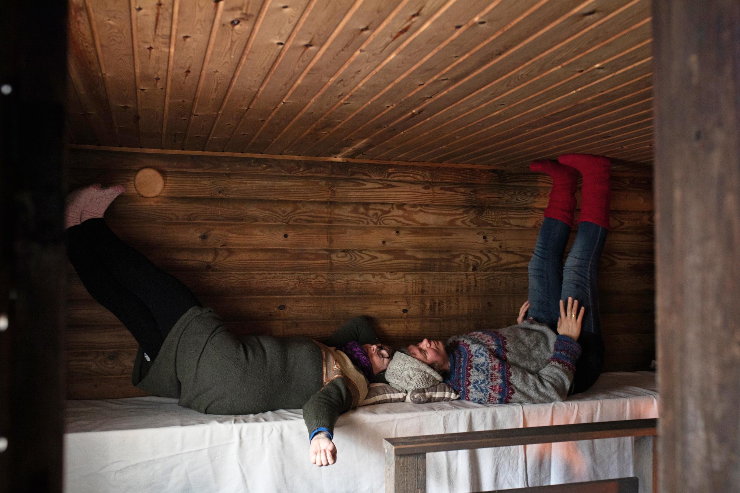 Women lying on the upper benches of the sauna