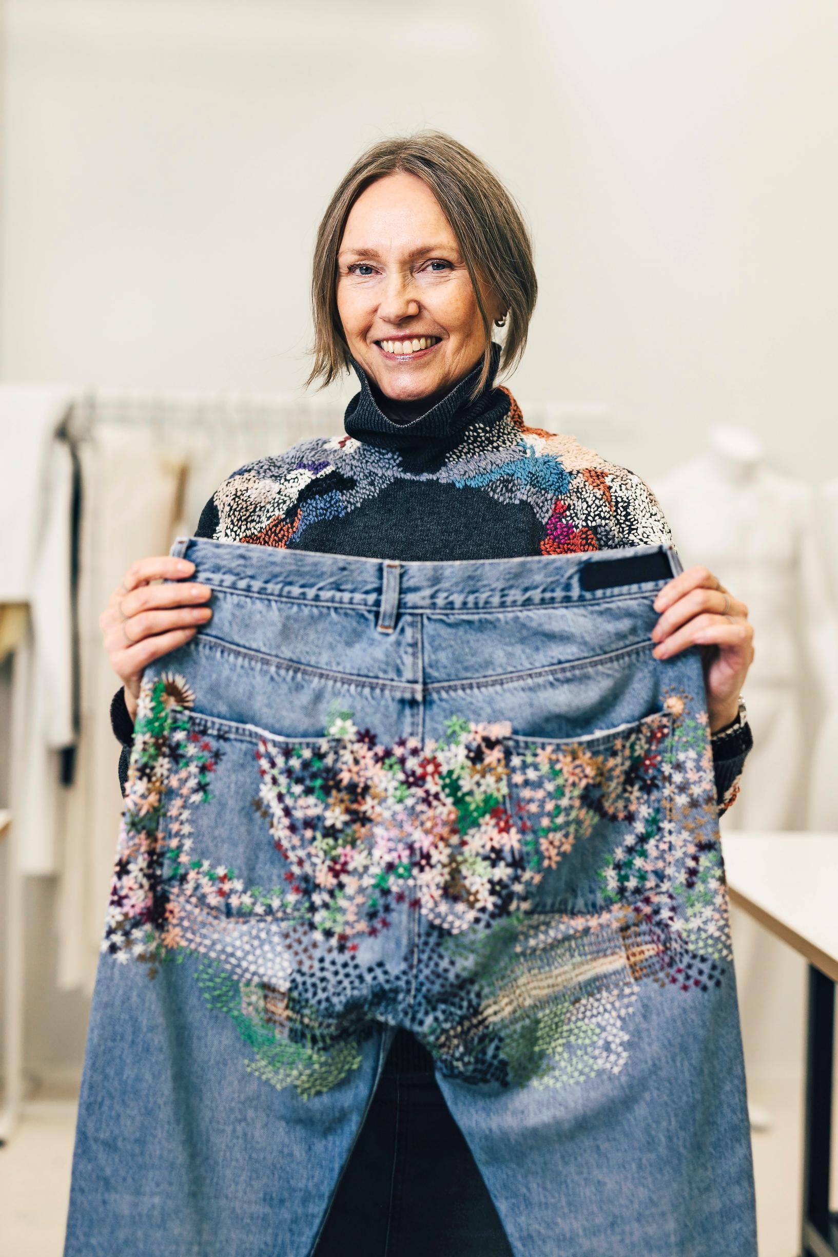 Minna holding the patched-up jeans.