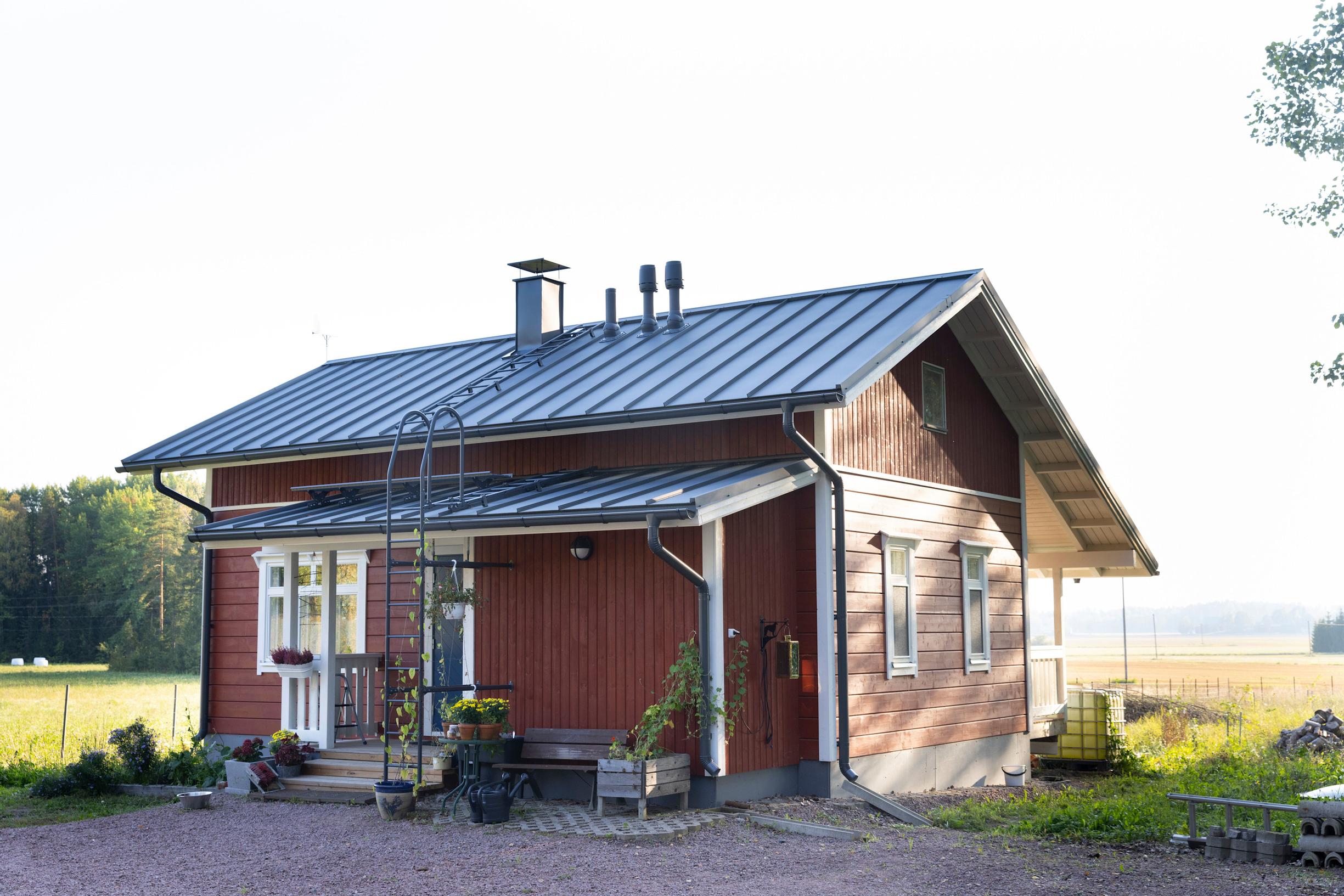 The front porch of the house, with a field in the background.