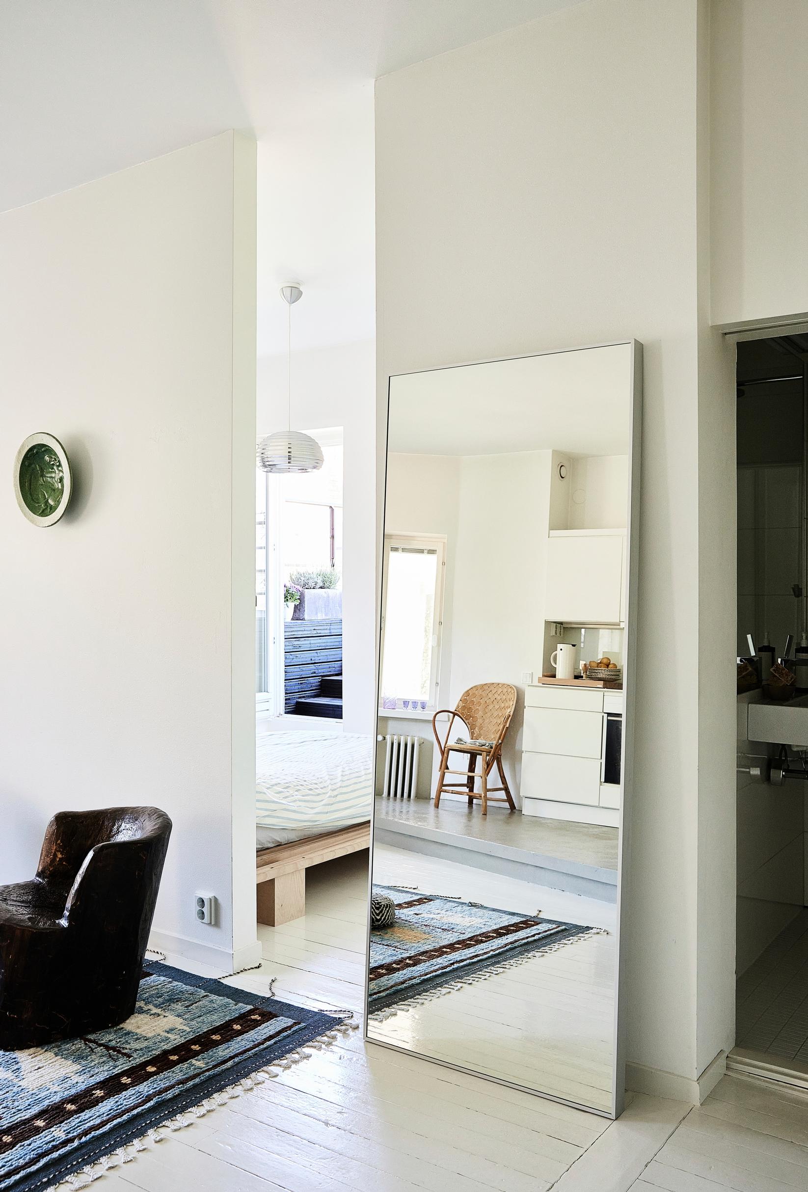 An oversize mirror leaning against the wall