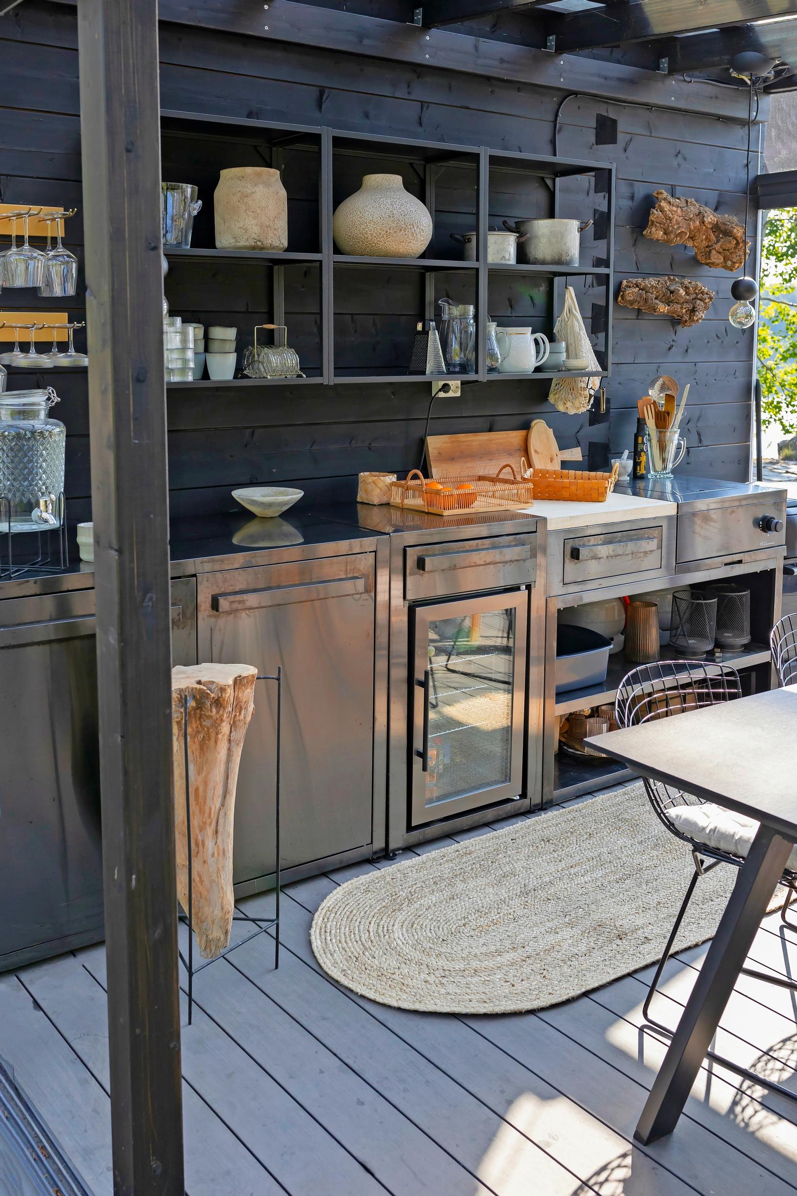 in the dark summer kitchen, gray cabinets and items on the shelves