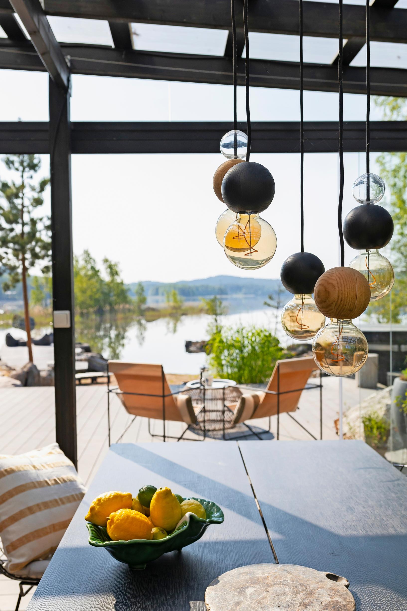 a table and garden chairs, a globe lamp, and the lake