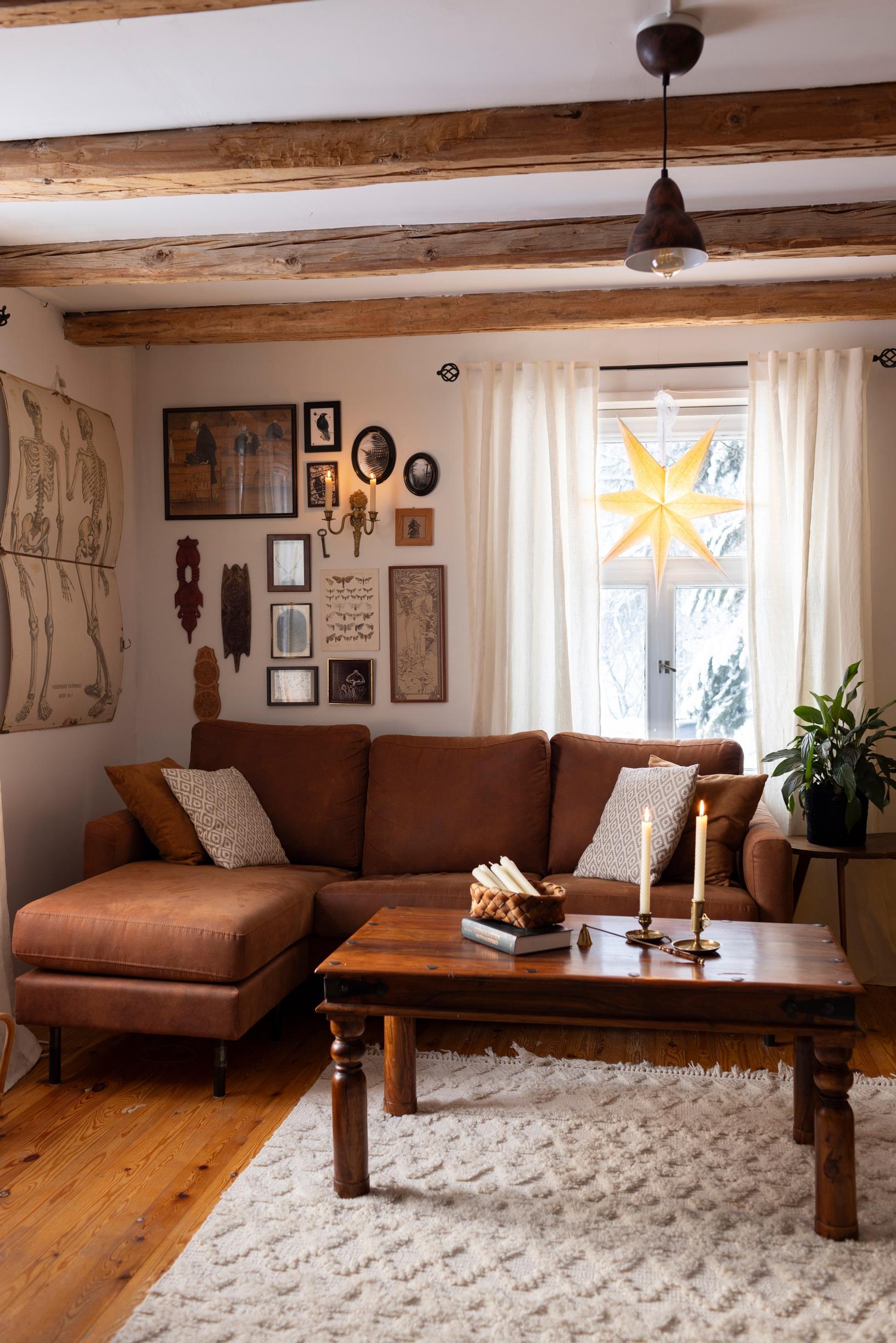 A living room with a collage of pictures on the wall