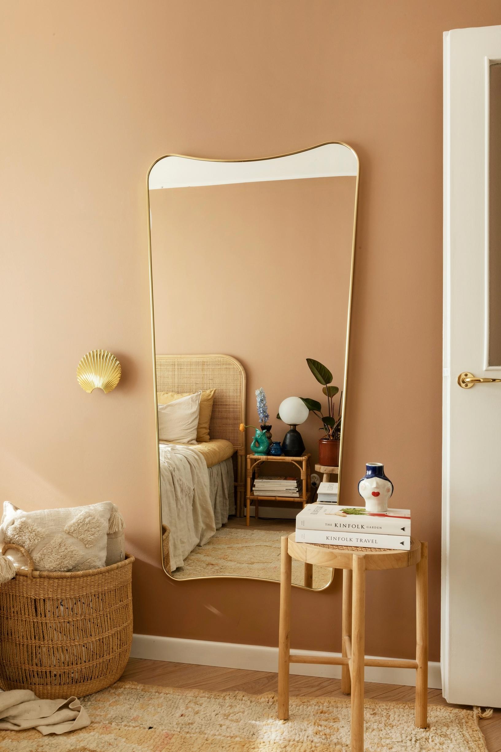 A large, softly edged mirror in the bedroom.