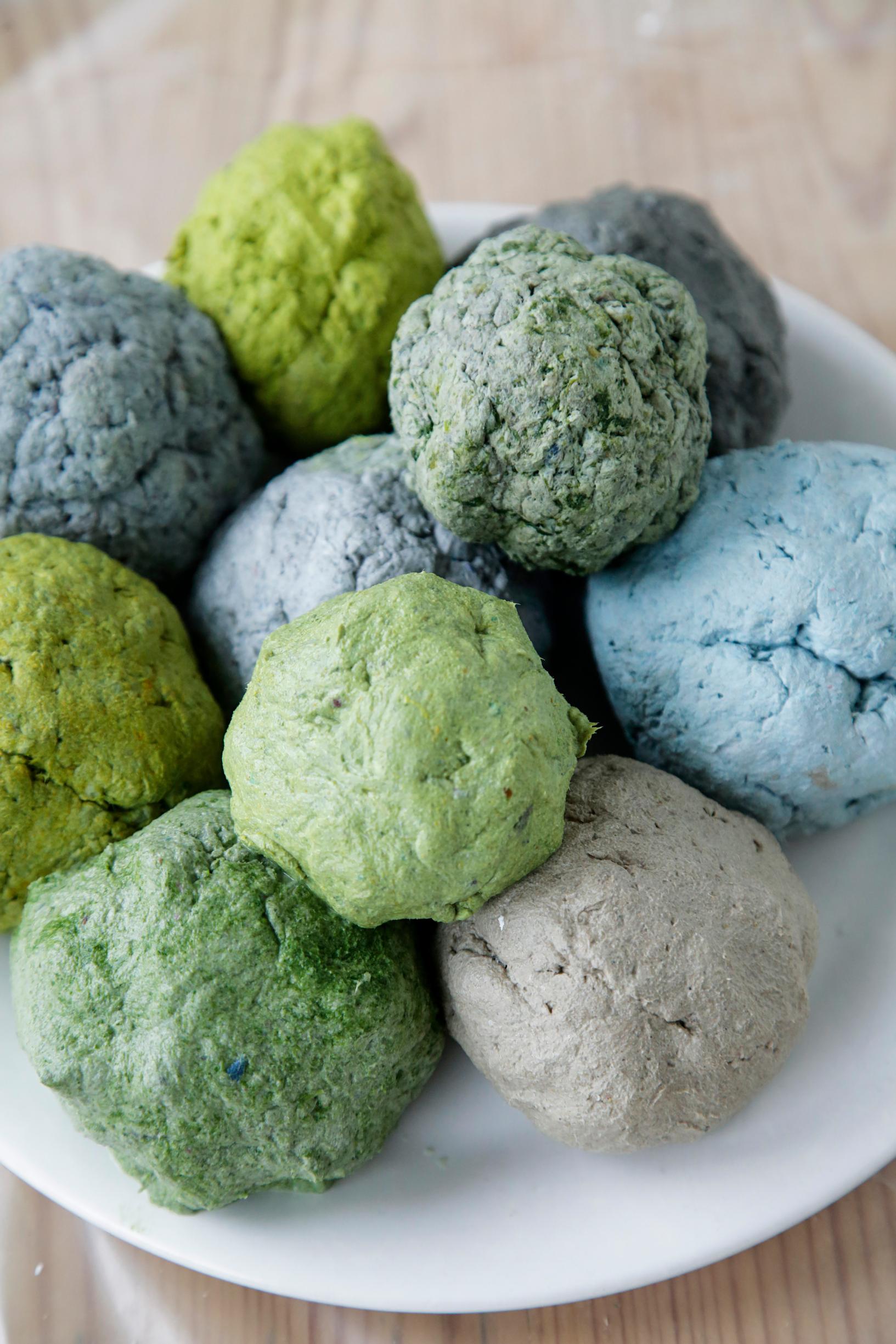 Stacks of differently colored papier-mâché balls.