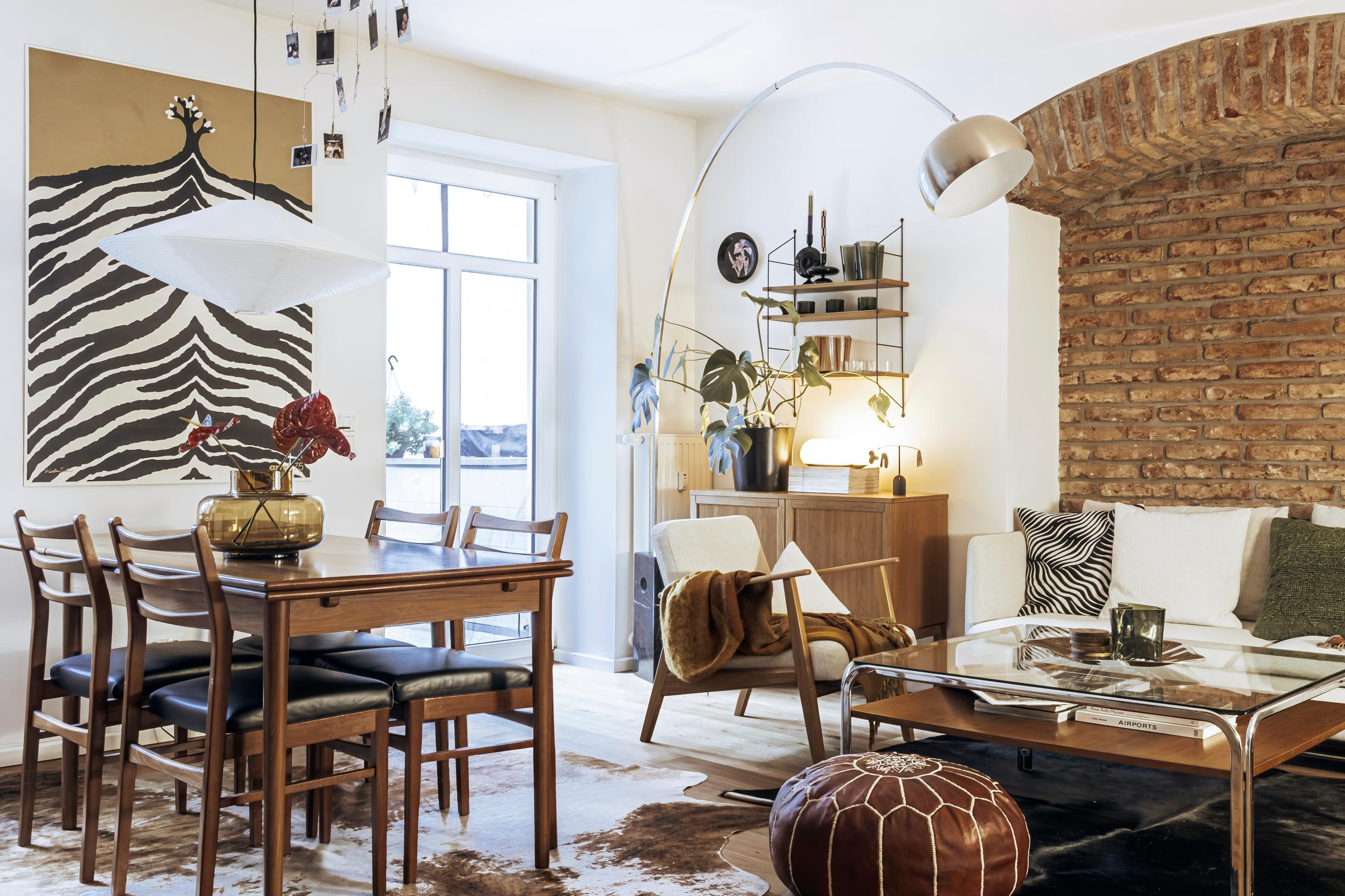 The Artek 75 Years poster and the dining set in the open living space