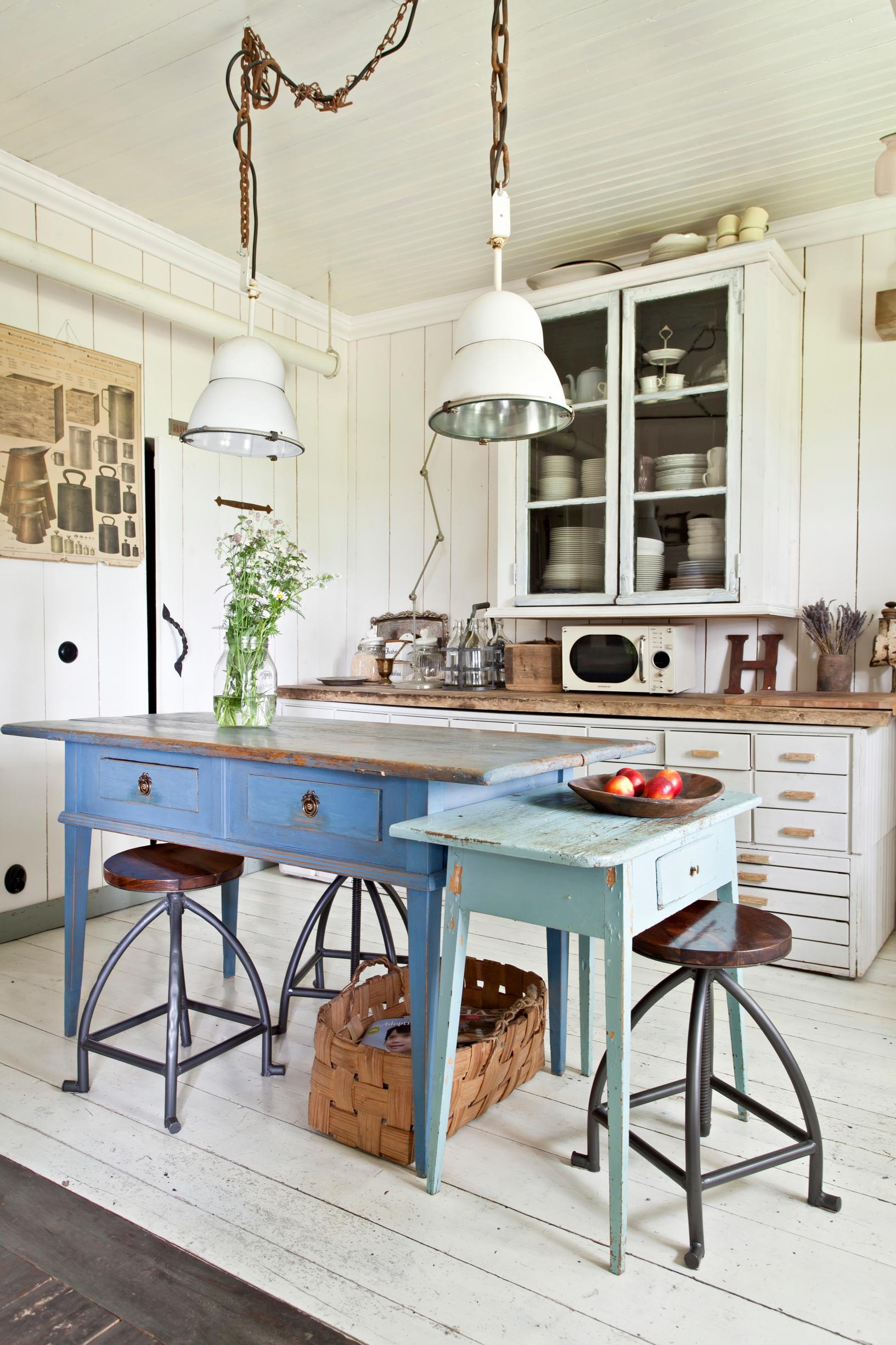 Beautiful side tables form an island in the kitchen.