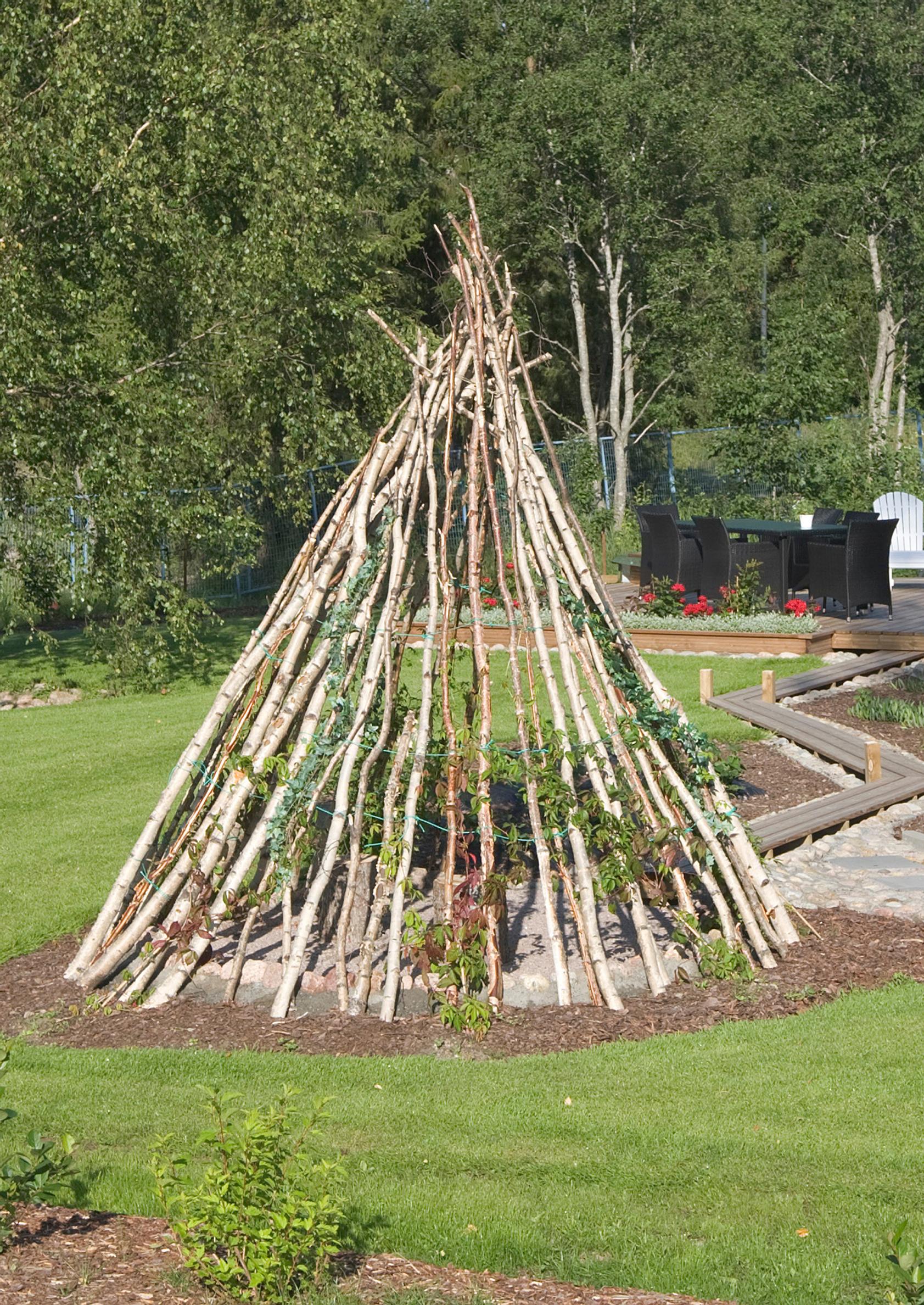 A tent made from thin tree trunks.