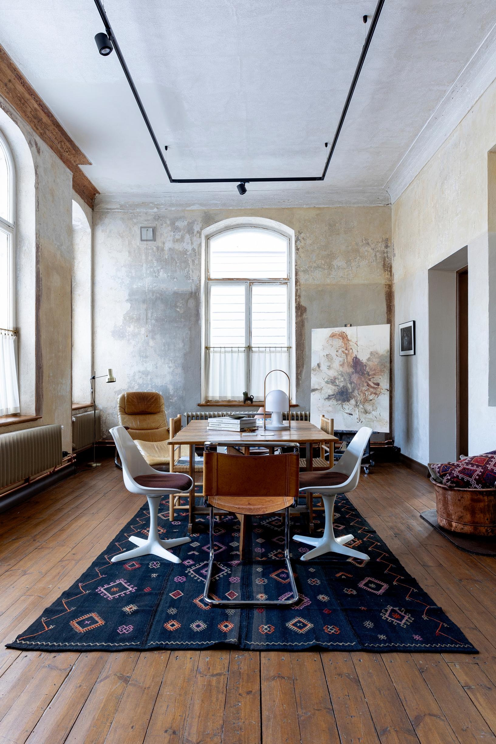 Table set and a large dark wool rug in the bank’s hall