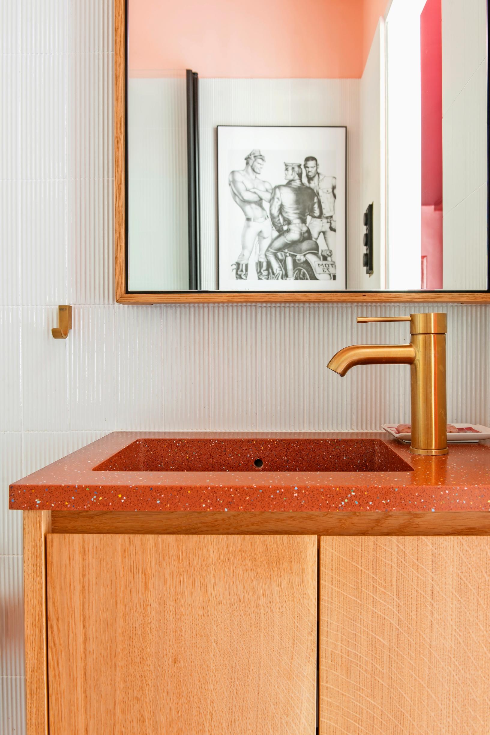 A bathroom with brick-red countertops.