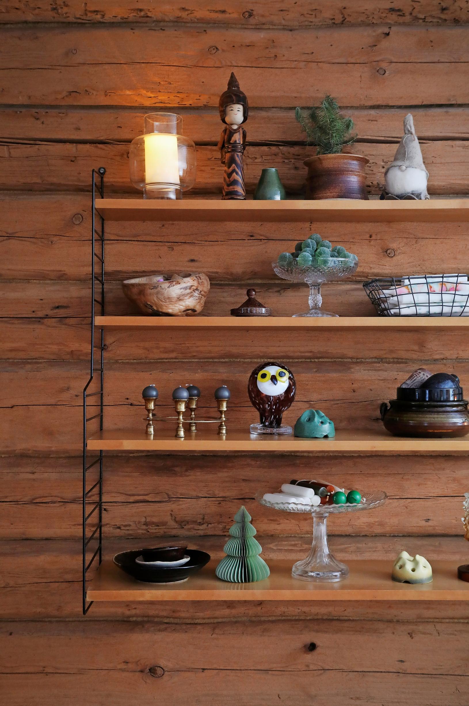 on the wooden shelf attached to the log wall, decorative items
