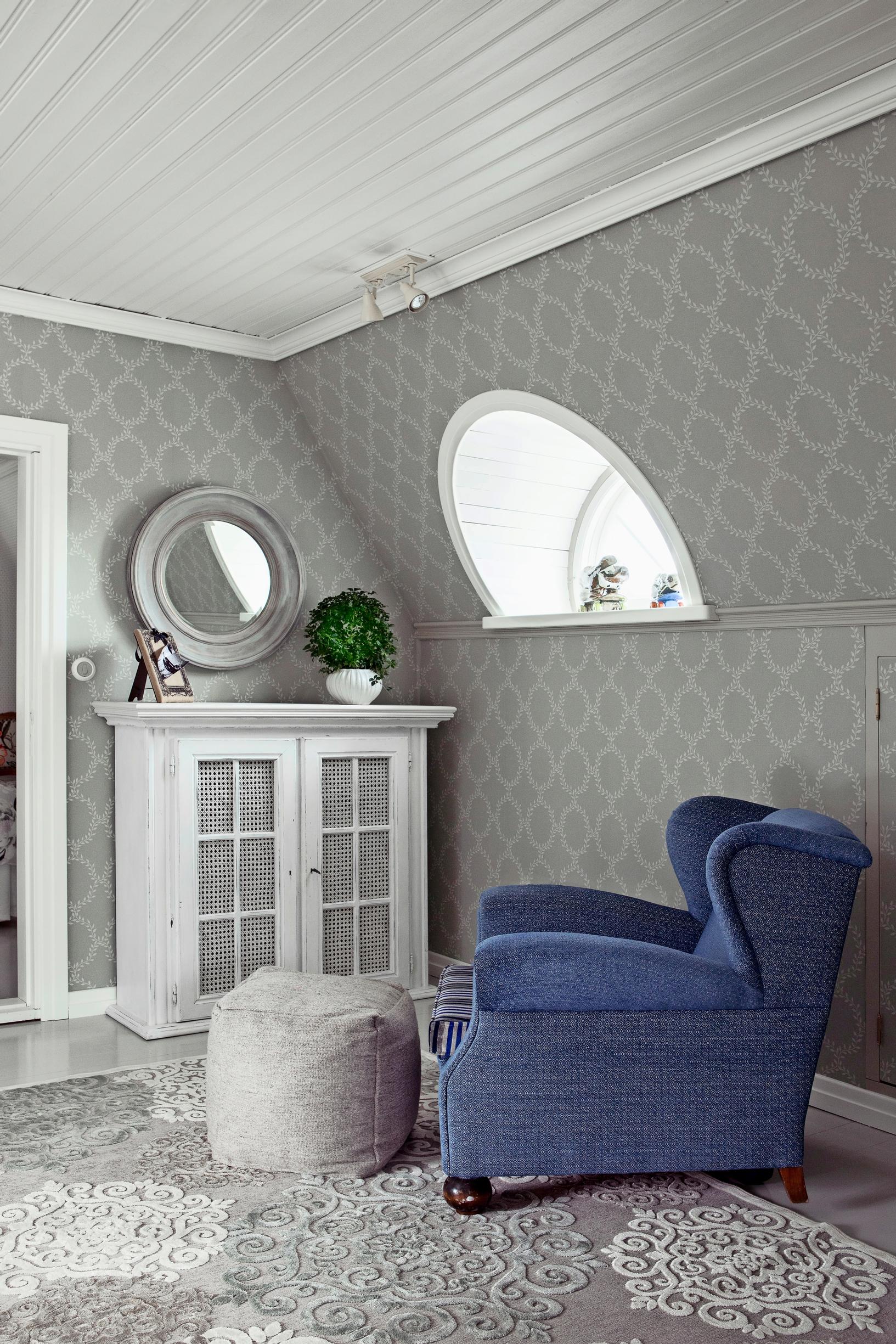 In the upper hall, there's a plush velvet armchair