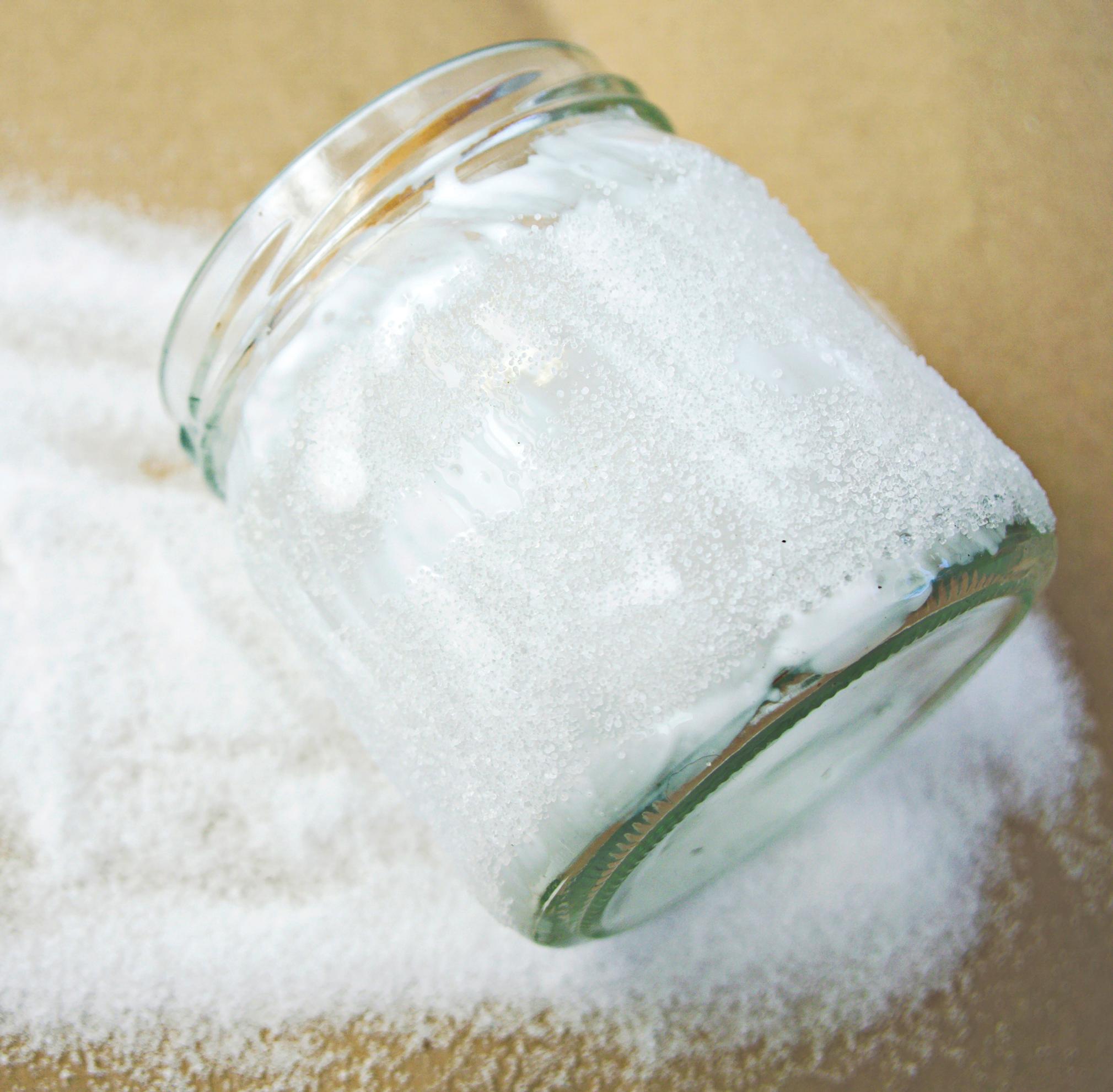 Sprinkling salt onto the glass jar