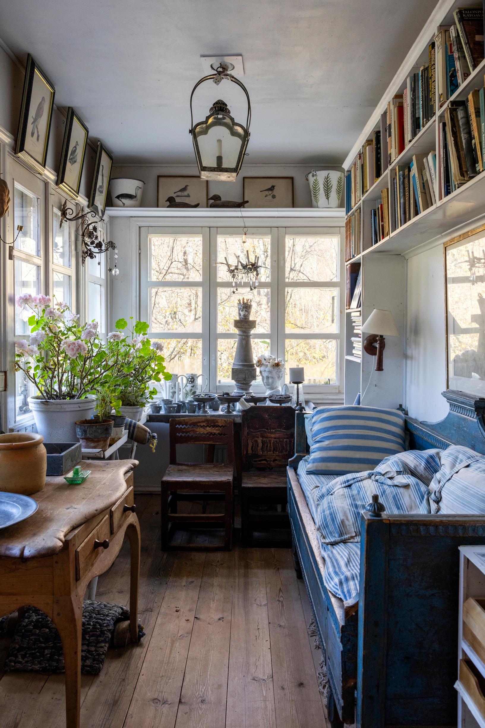 Porch with a sofa cushioned by pillows.