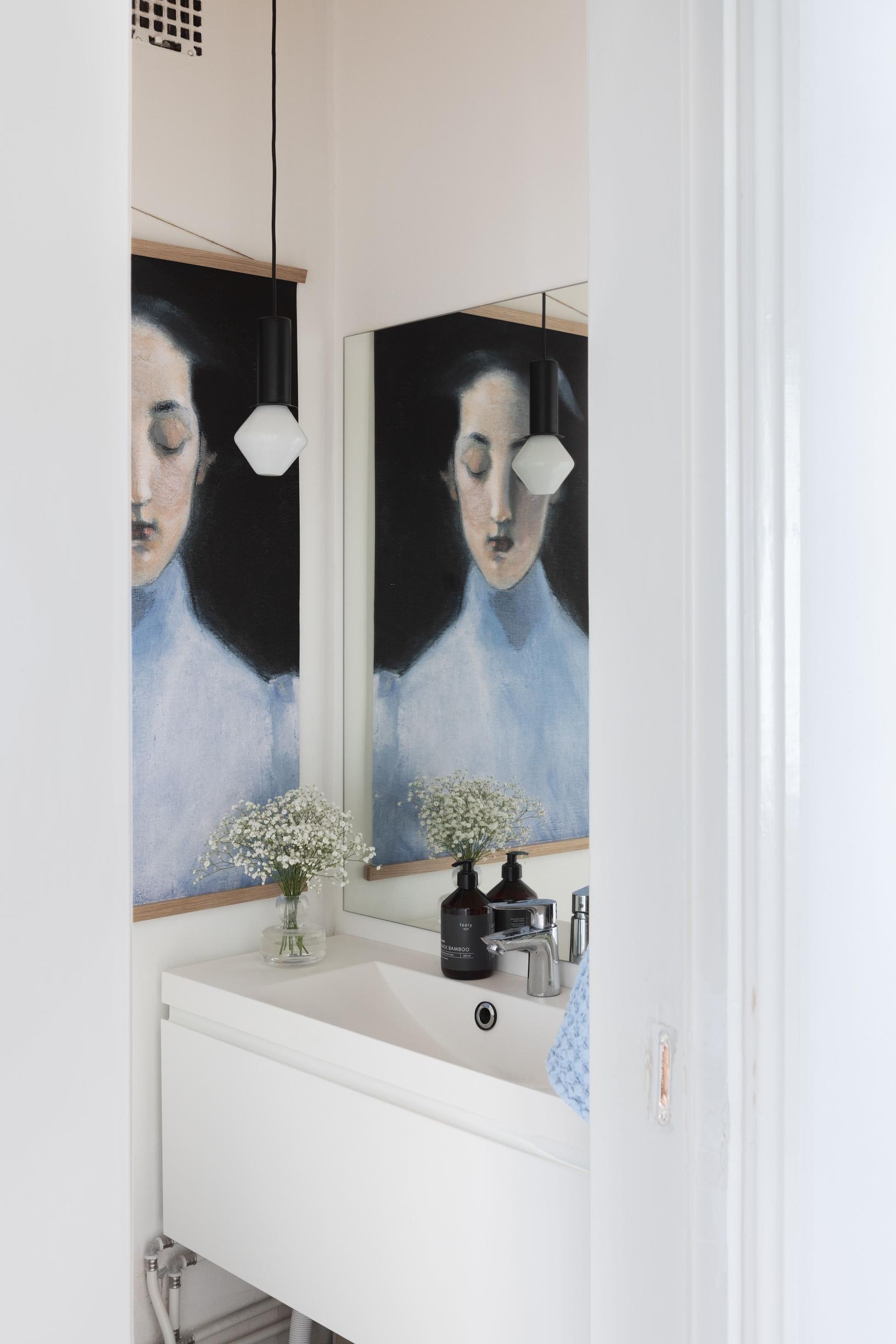 Powder room with a poster of a woman on the wall.