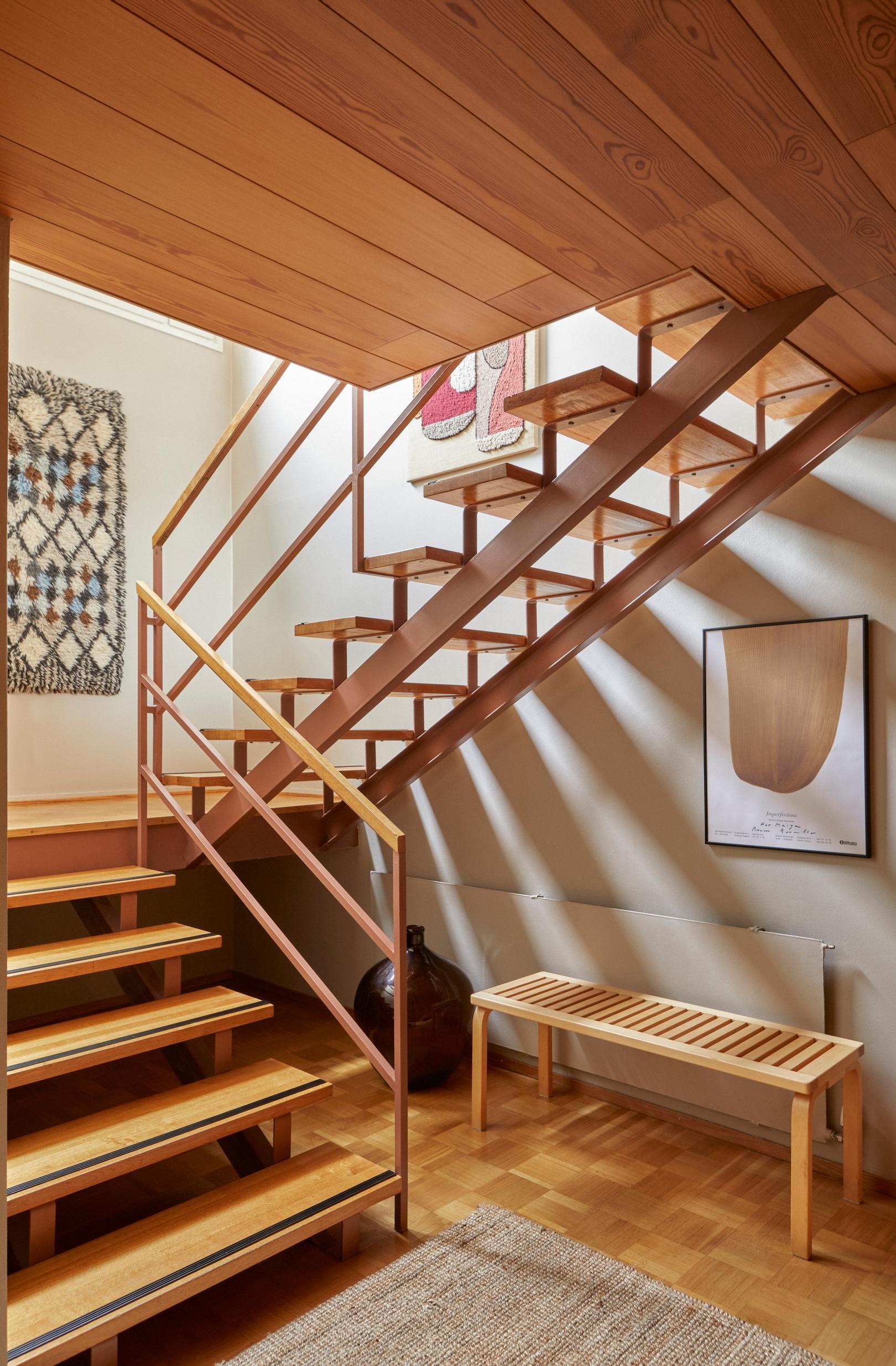 The original floor, ceiling, and staircase remain untouched during the renovation.
