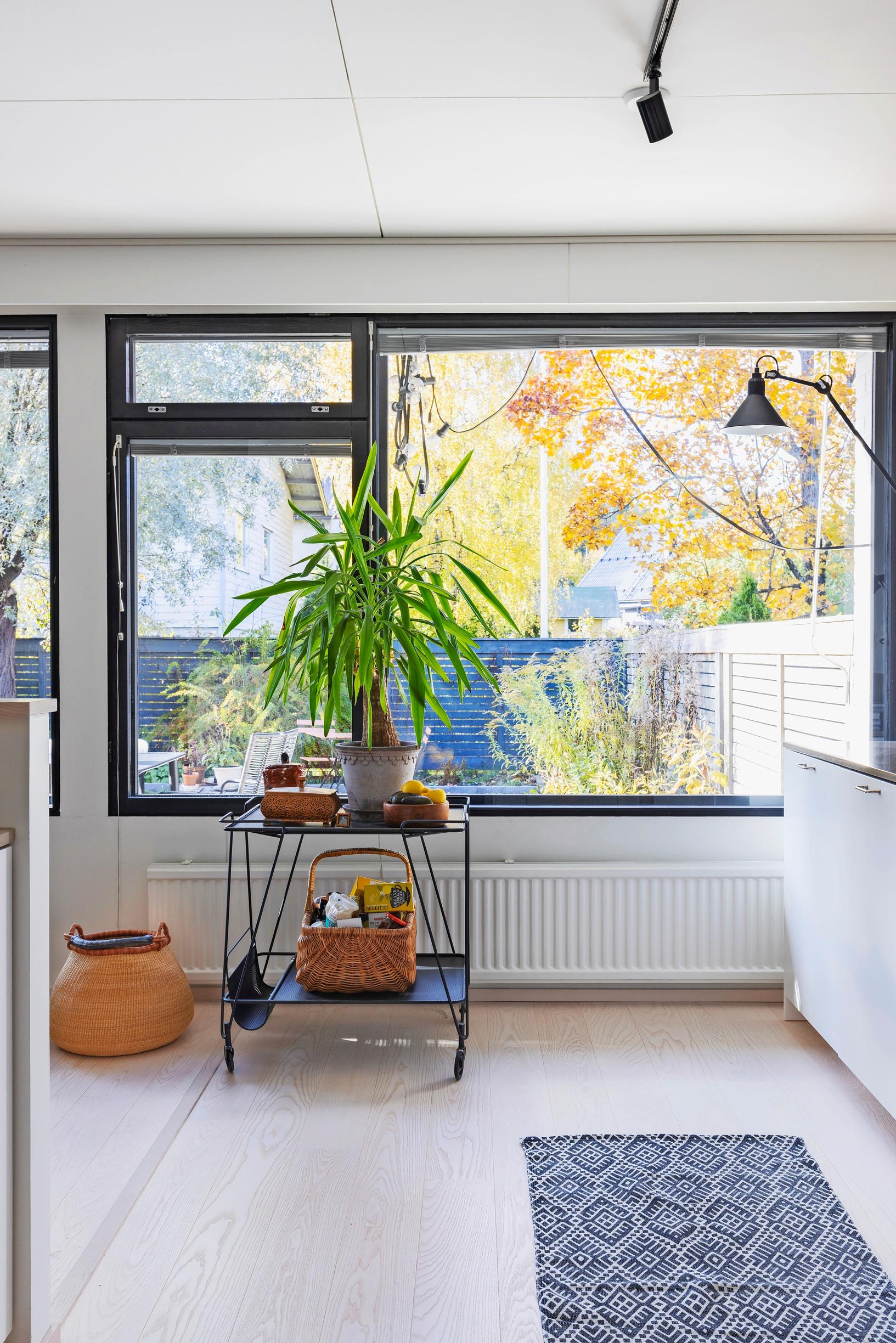 A large window with a bar cart in front