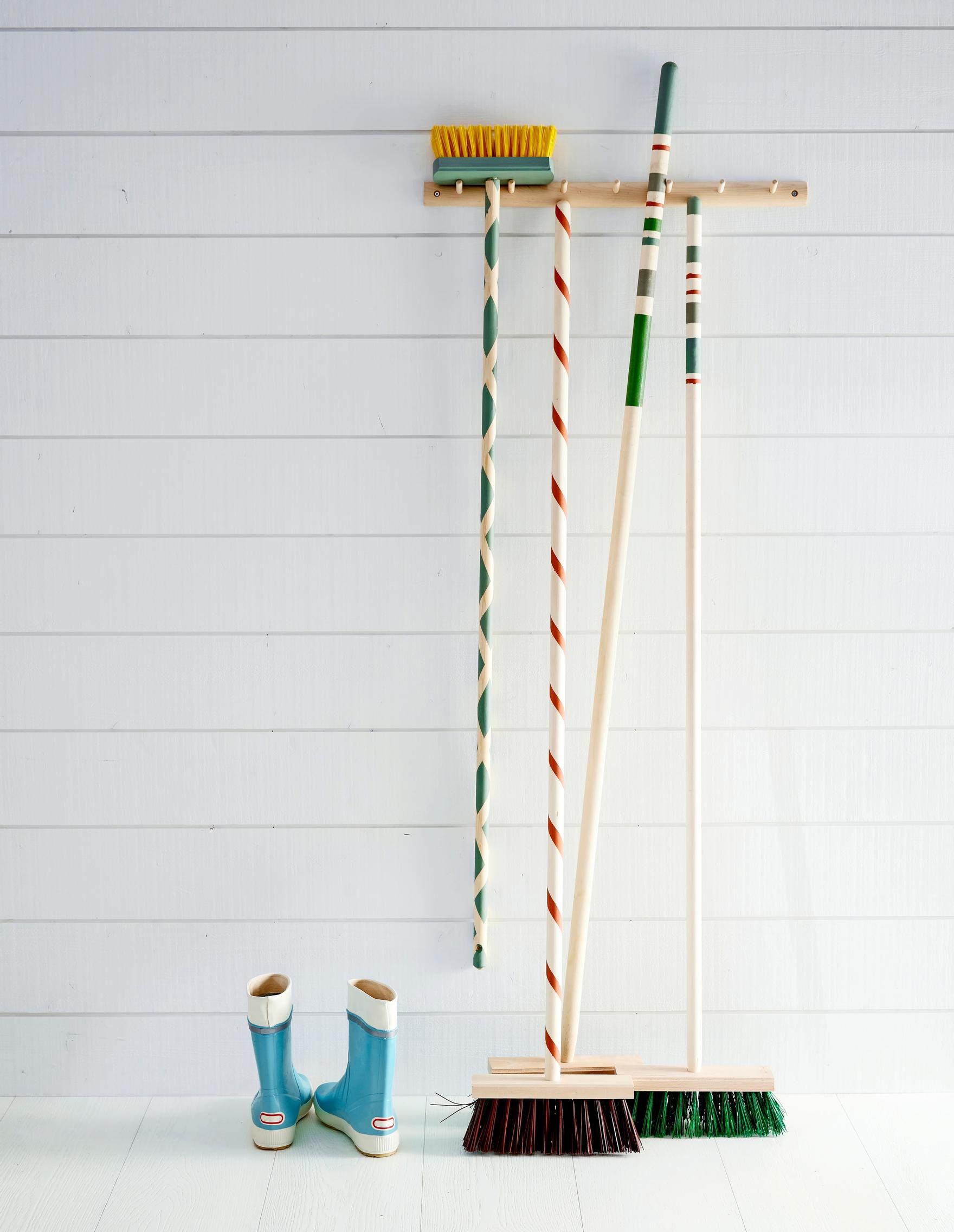 Street brooms with handles painted in stripes.