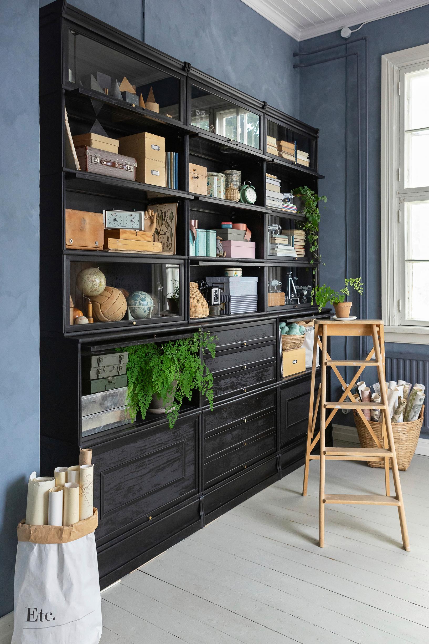 Give a cherry-finish bookshelf a modern makeover with black linseed oil paint