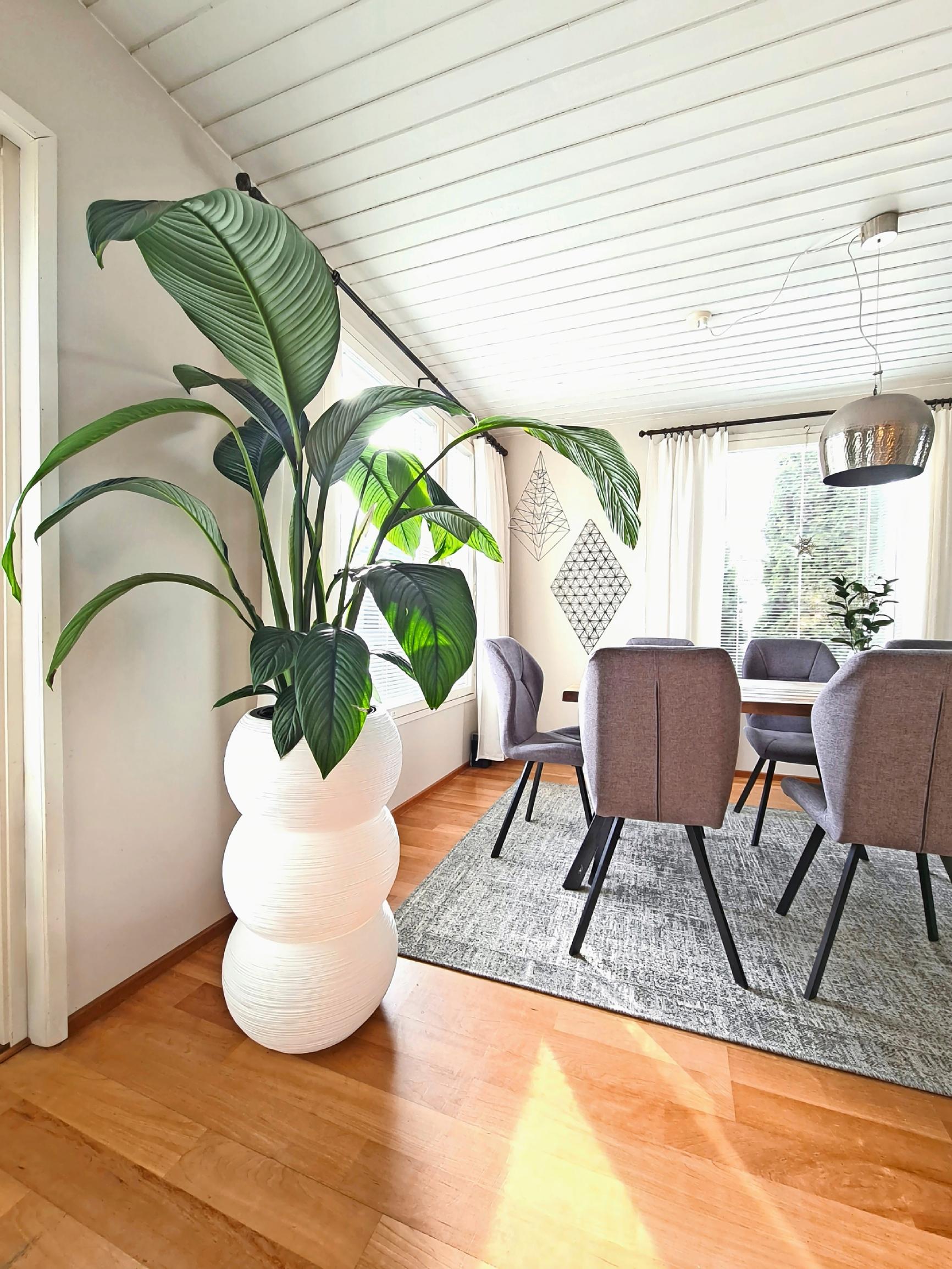 A tall, three-section DIY planter for large houseplants on the floor.