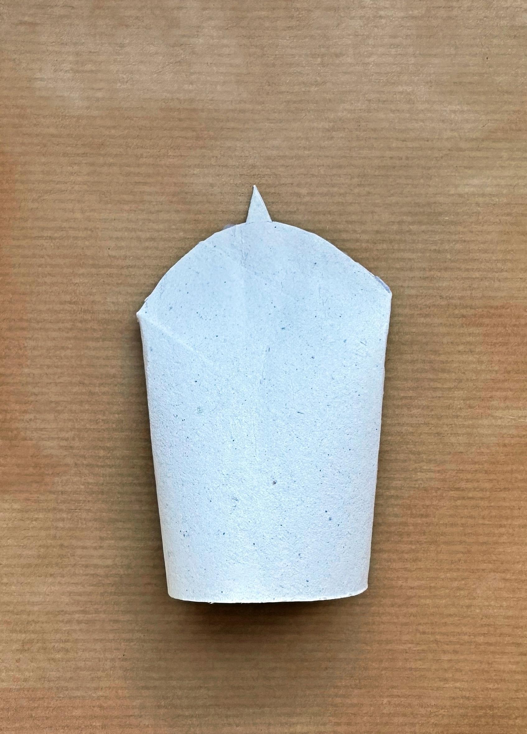 One end of the toilet paper roll is trimmed into a curved shape, and a beak-shaped piece is glued in the center.