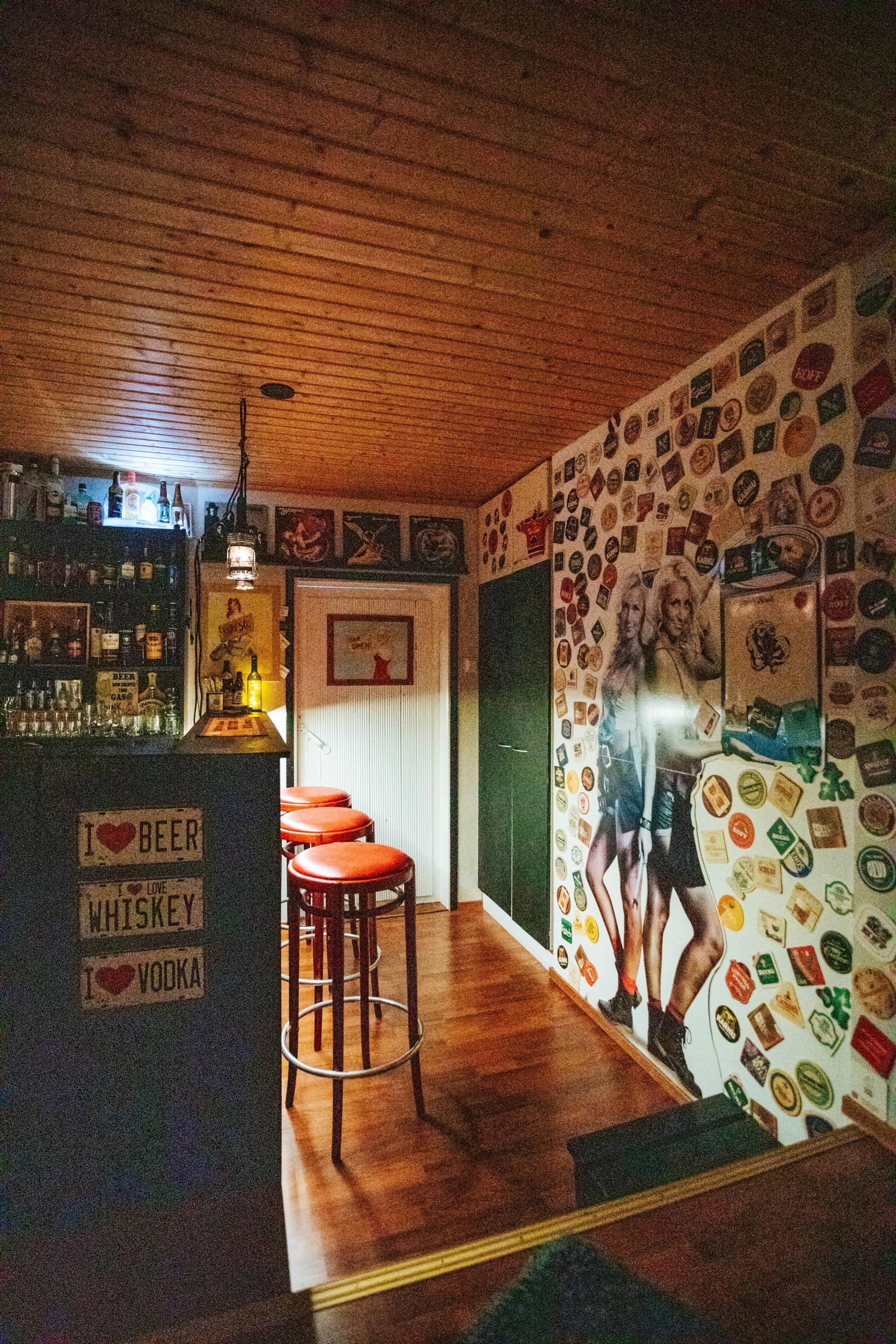 view of the home pub with a bar counter and tall stools