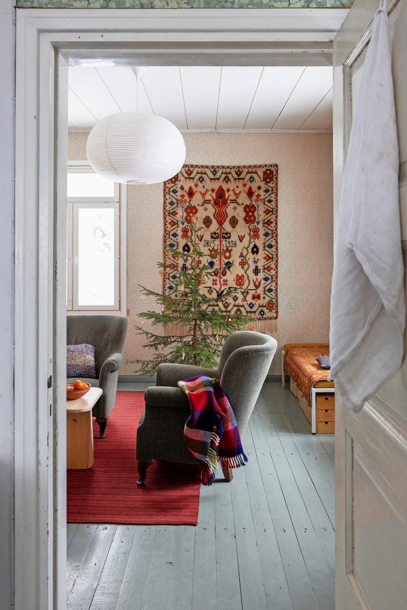 Wall rug, small Christmas tree, and sofa set